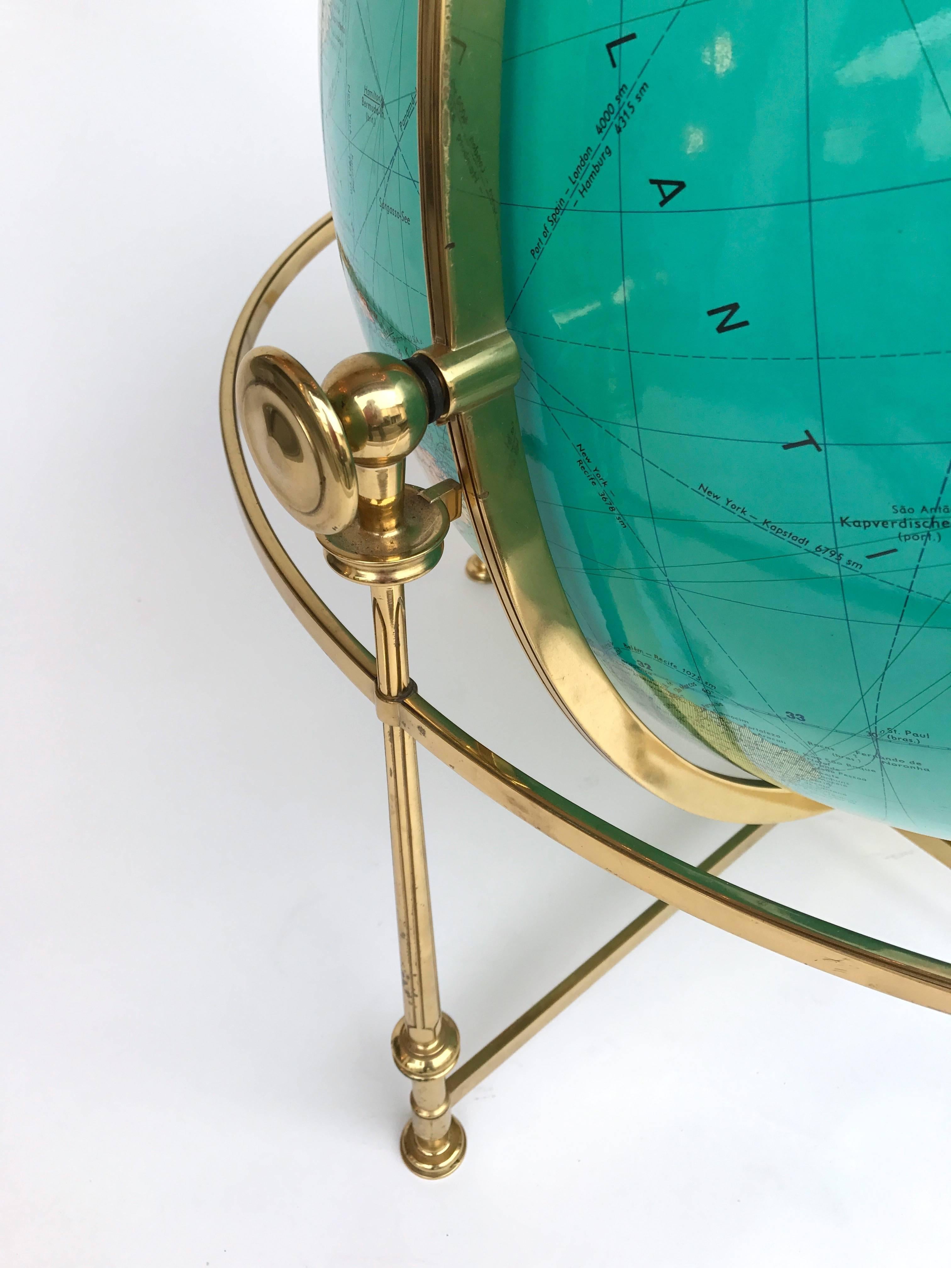 Huge lightning world globe map or ground world map. Decorated brass structure. Datation before 1971, Democratic Rep. of Congo is on the globe after 71 it become the Zaire. The editor name from Munchen is on the globe.