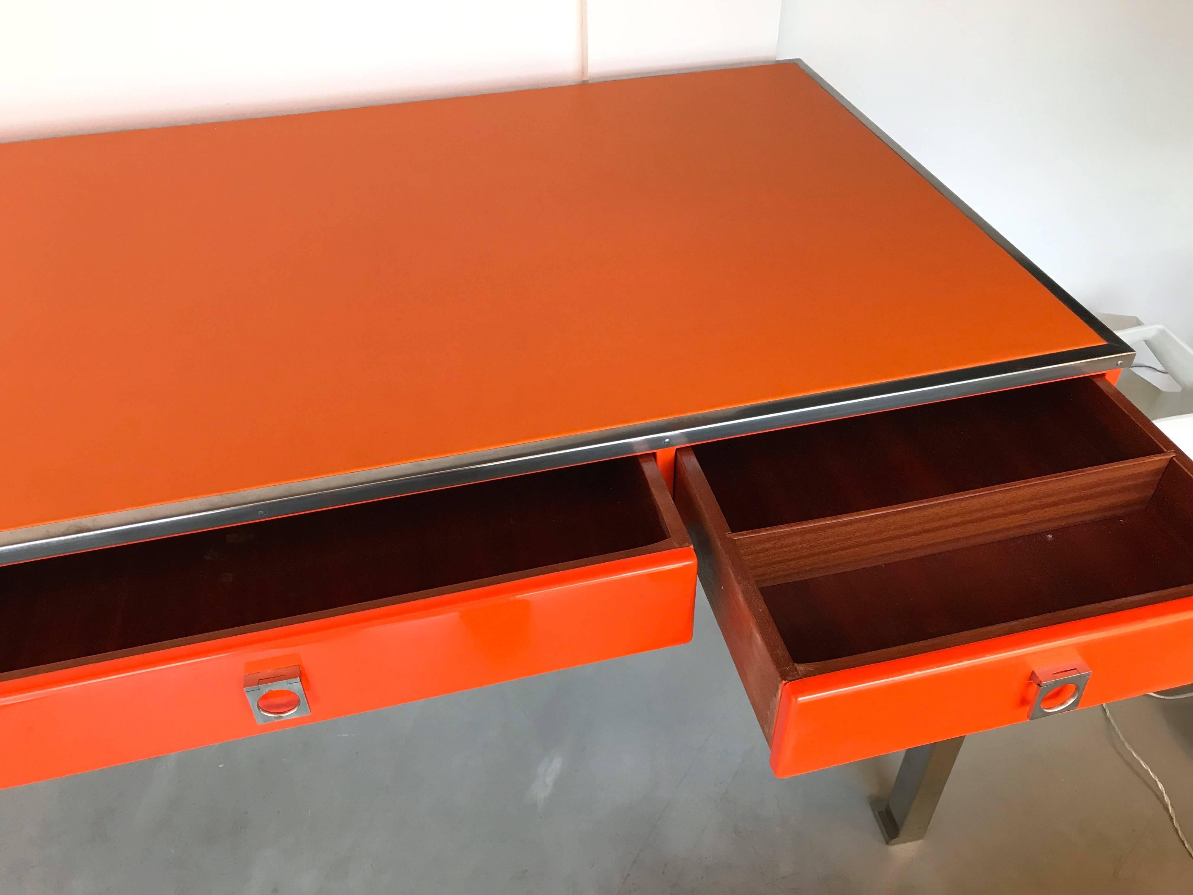 Orange lacquered desk writing or console table model 130 by the designer Guy Lefevre for Maison Jansen. Leather top, mahogany wood interior drawers, nickelled brass feet. Famous manufacture like Bagues, Jean Claude Mahey.