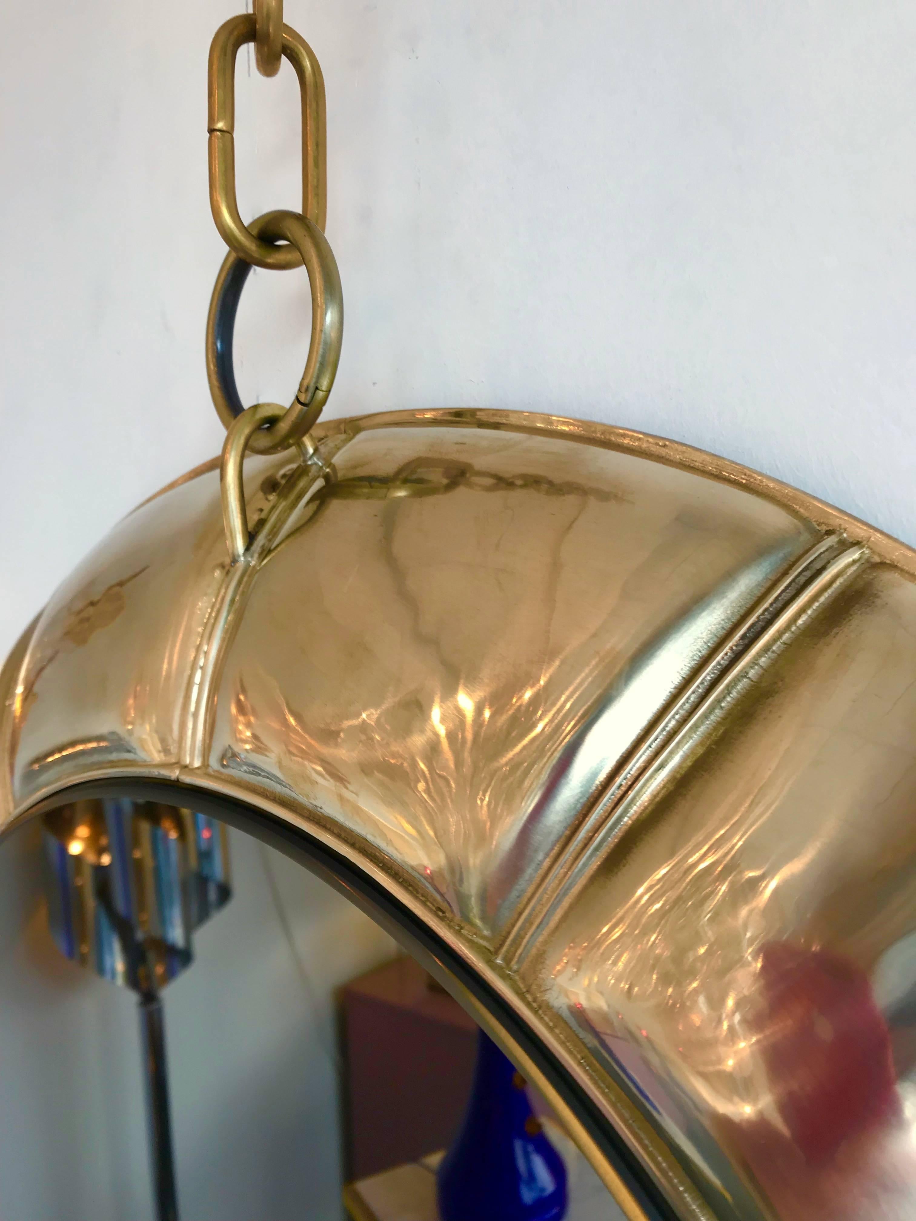 Mirror brass hanging by chain. Limited edition of 10 exemplary.