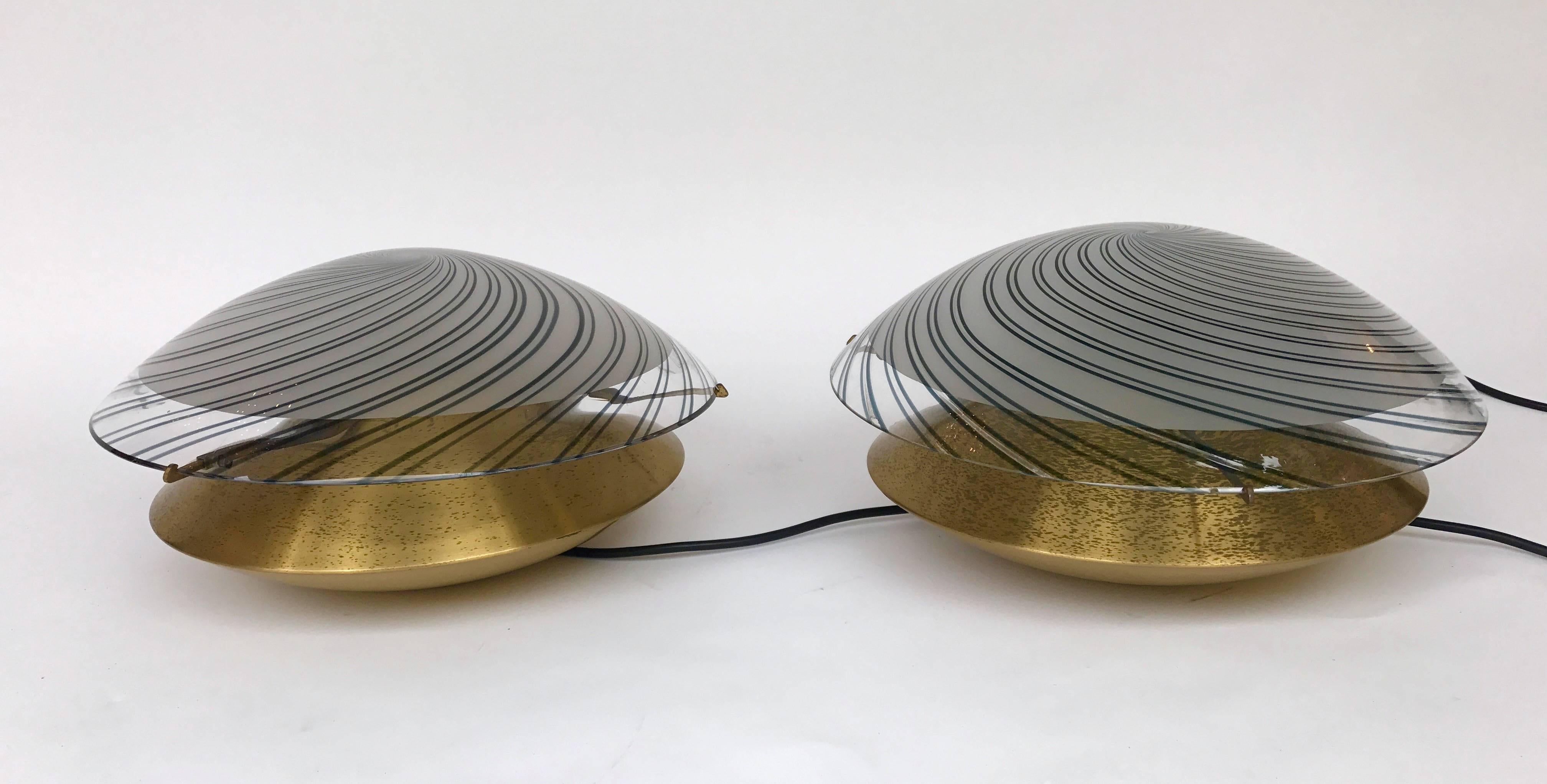 Space Age rare mushrooms or Ufo table lamps by the editor Esperia. Nice size. Brass base and Parma purple spiral Murano glass dome. During the 70s the manufacture was famous with the designer Angelo Brotto. Famous maker like Mazzega Murano, Venini,
