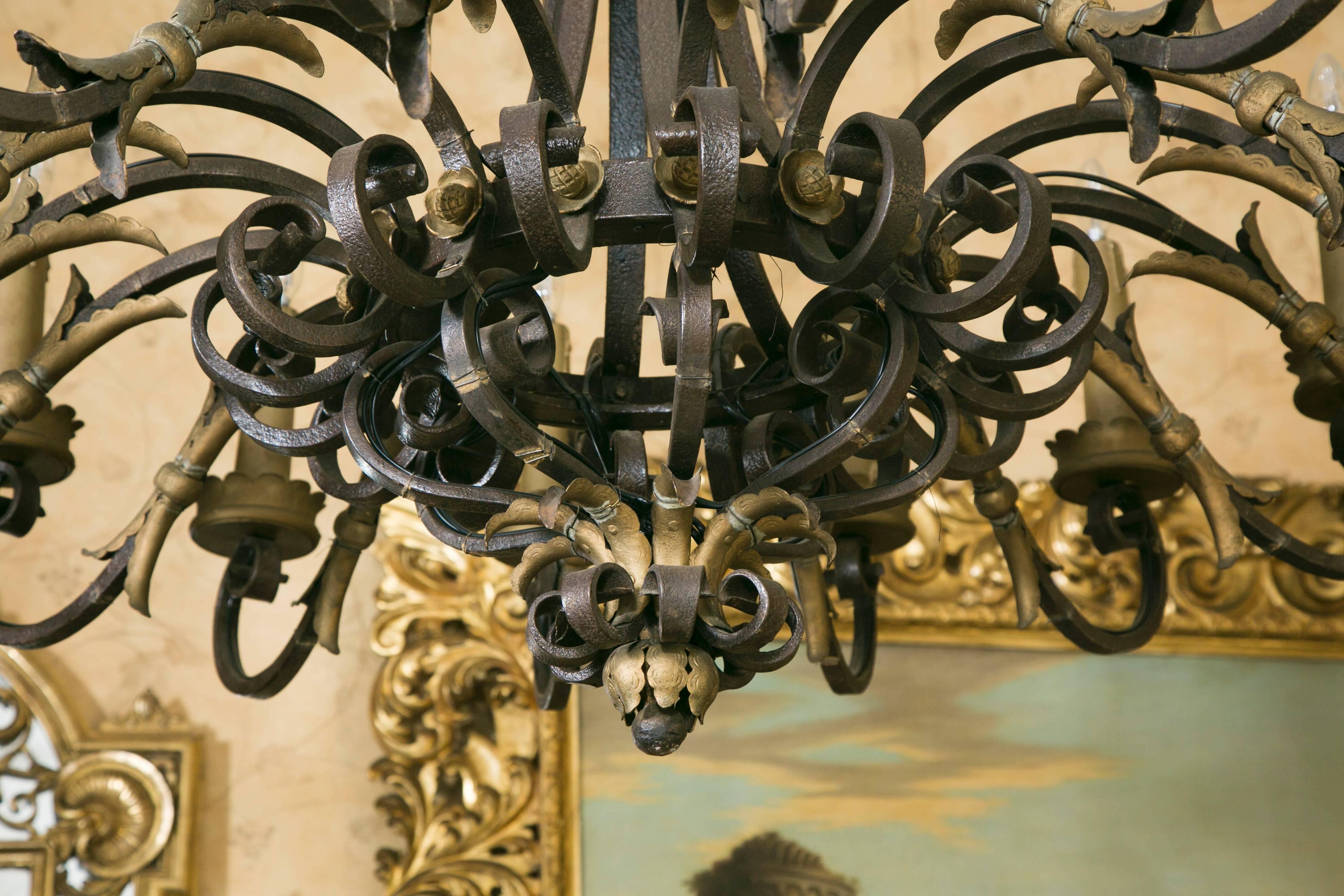 Wrought iron chandelier, 16 branches with light, some parts have a gold finish.
Wired at EU standard.