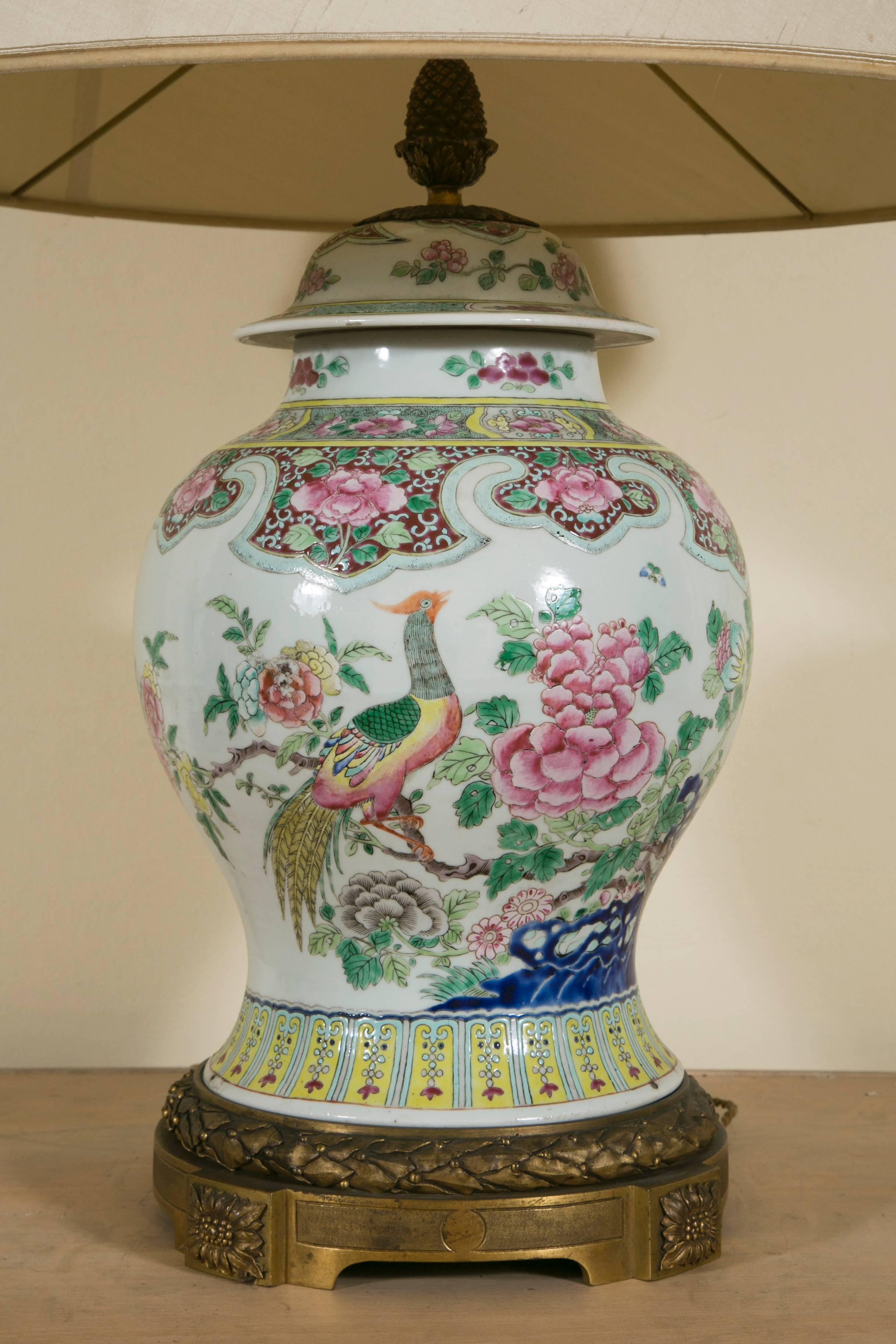 Polycromed Chinese jar with its cover on a LXVI gilt bronze base and pine finial made as lamp base.

Wired to the EU standard
sizes with shade, height 88cm diameter 56cm.
Worn fabric lamp shade available free.