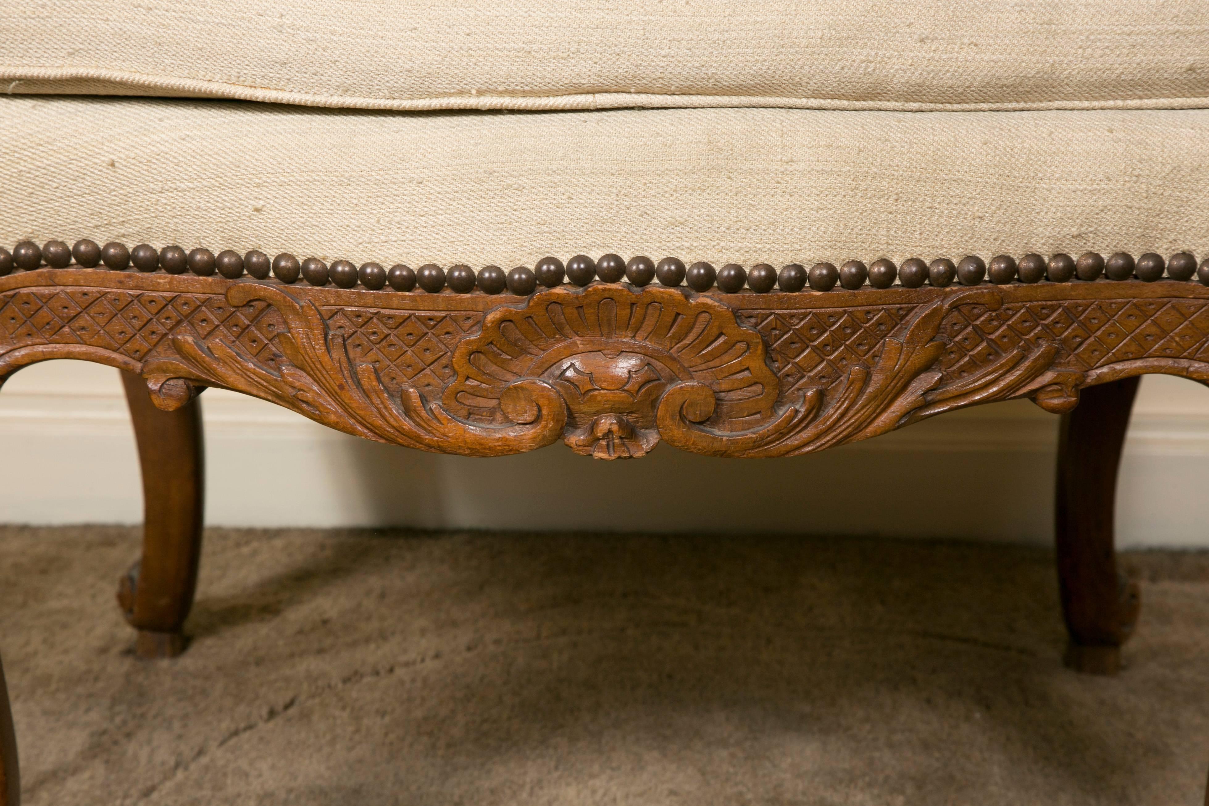 Beautifully executed with fine attention to details, French Regency style carved wood stool on cabriole legs ending with snail feet, decorated with shells and foliage

sizes are with cushion.