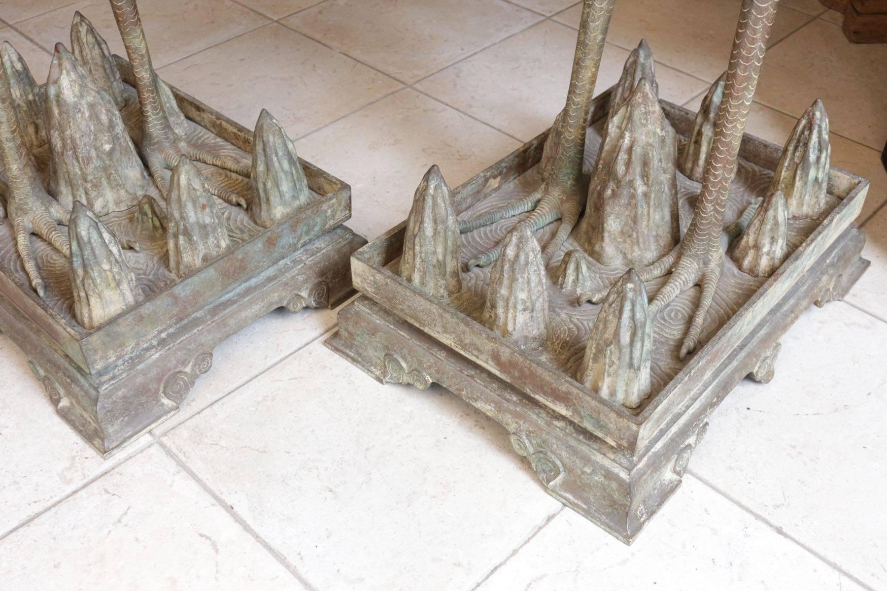 The cranes are standing on a rectangular plinth with their heads raised
They are naturalistically cast with detailed feathers on wings and legs, the base
is surmounted by numerous small peaks

Symbolizing longevity, the crane has always been an