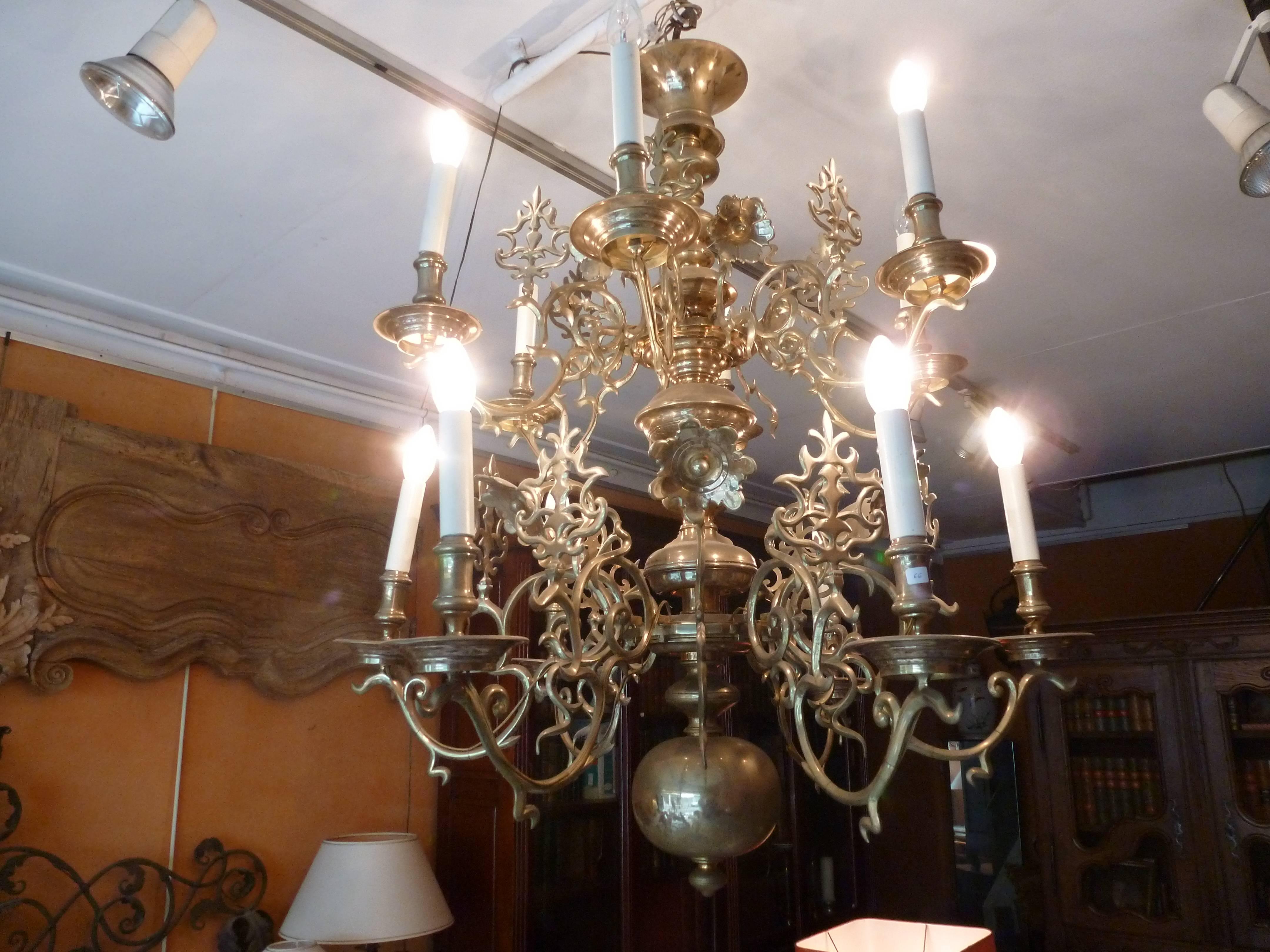 Nice and large cast bronze Dutch chandelier, two rows of six arms with a decoration on the arm, in between, on a half arm large bronze flower and 
stylised palmette.
Wired to the EU standard.