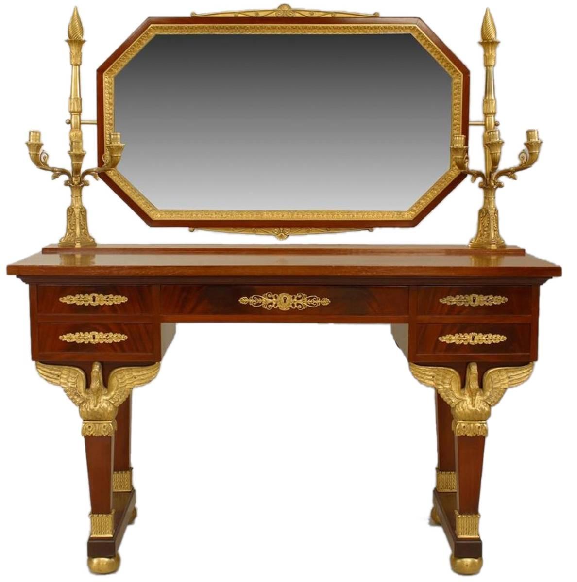 From the third quarter of the 19th century, a Second Empire lady's dressing table with elegant gilt bronze swan supports mounted to legs, octagonal shaped tilting mirror and three arm candelabras at each end. Four drawers, two presumably for