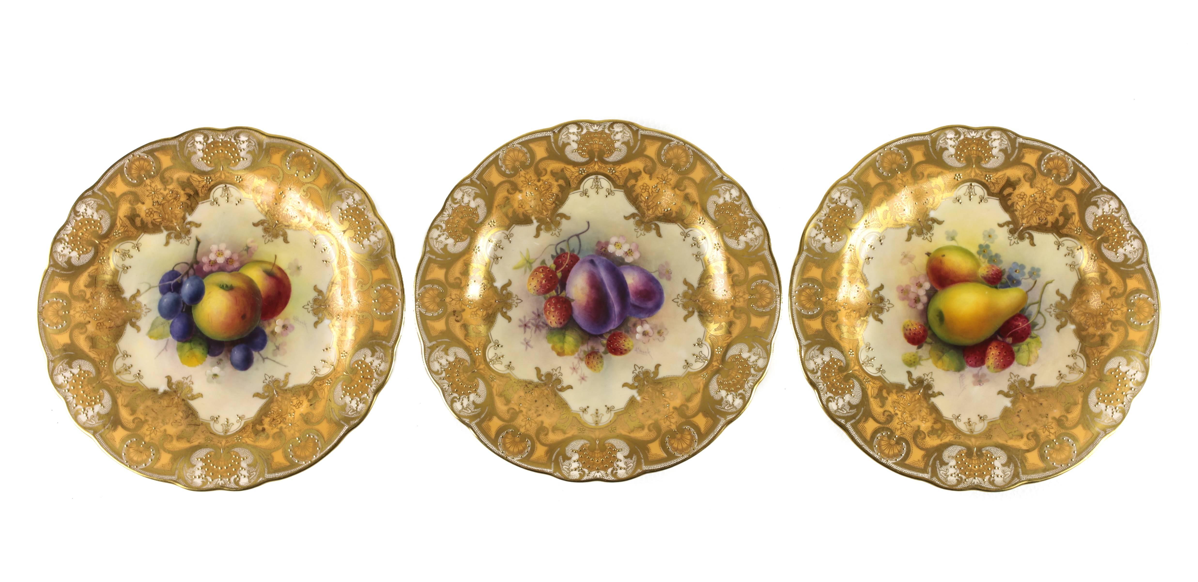 A striking set of eight cabinet plates by Royal Worcester, retailed by Davis Collarmore & Co., New York, the central hand-painted reliefs depicting various fruit and floral arrangements, each signed A Shuck for Albert Shuck, a formidable turn of