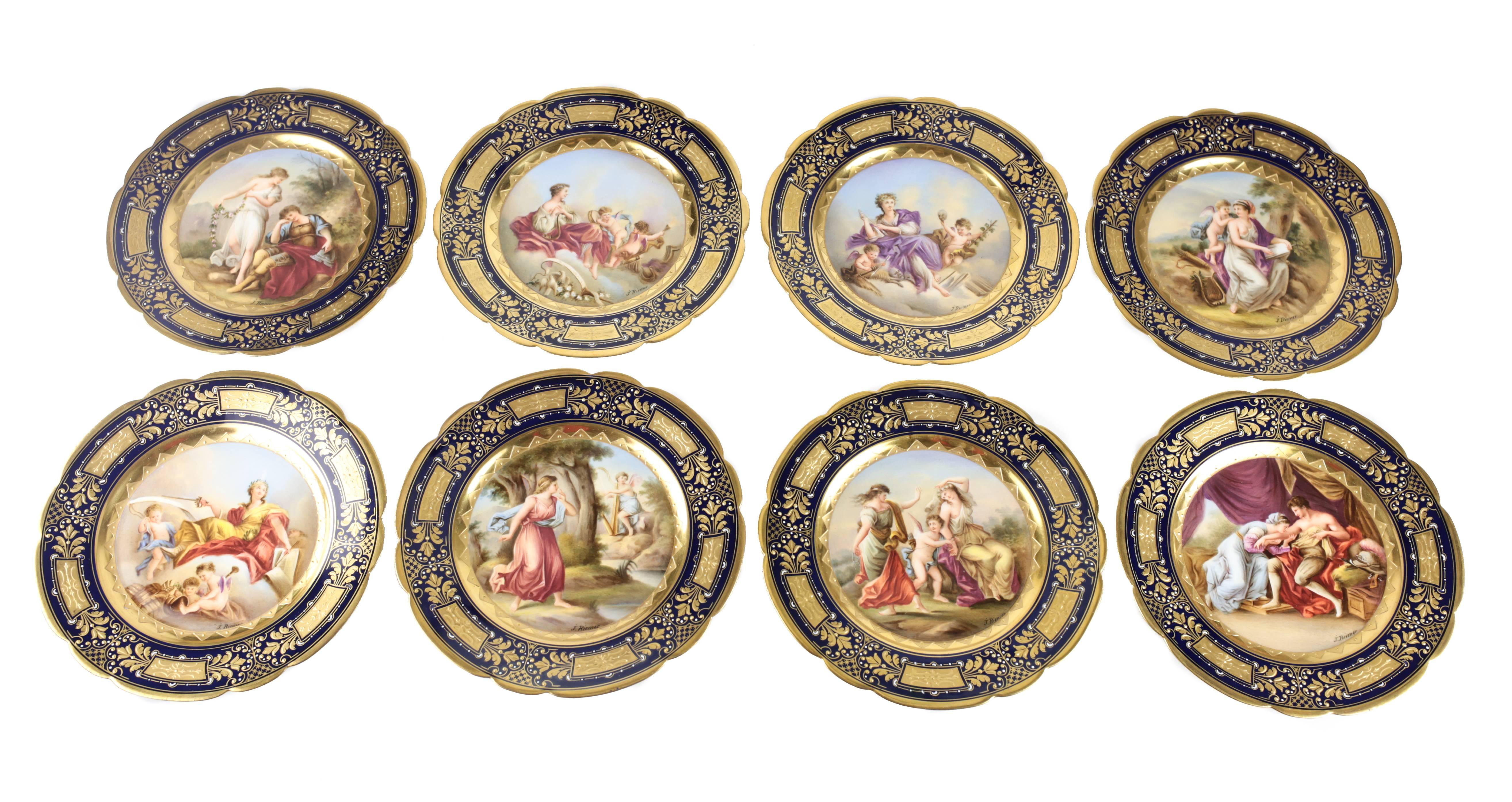 A fine late 19th century porcelain dessert service for eight consisting of eight dessert plates, one tazza and four compotes. Each with hand-painted mythological scenes by J. Riemer on a cobalt blue ground, gilt panel borders and elaborate