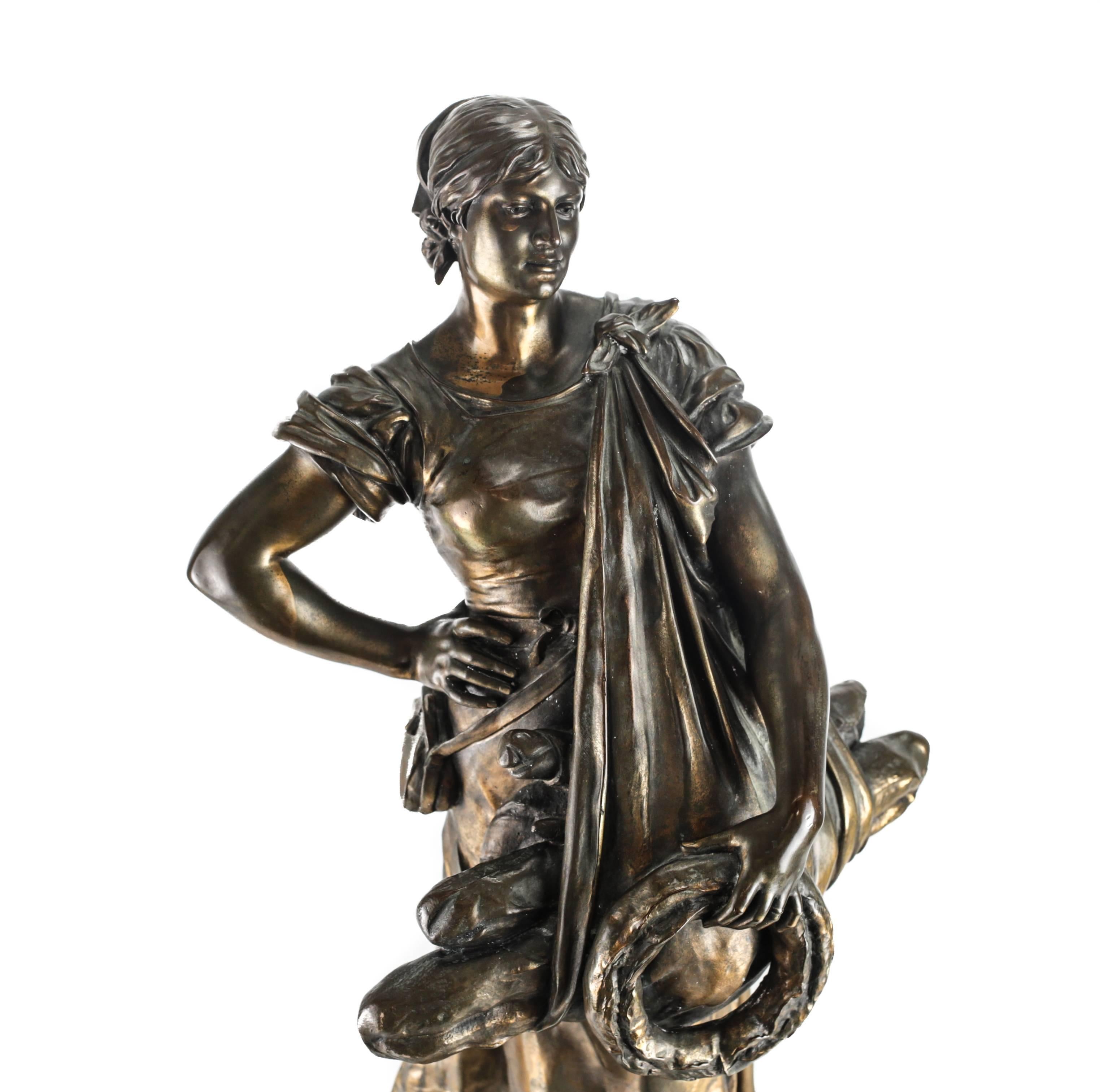 A fine French parcel-gilt and patinated bronze sculpture depicting a bread seller, emblematic of harvest. The bronze-mounted to a remarkable champleve enamel base. 

The bronze impressed with the esteemed foundry mark of Thiebaut Freres Fondeurs,