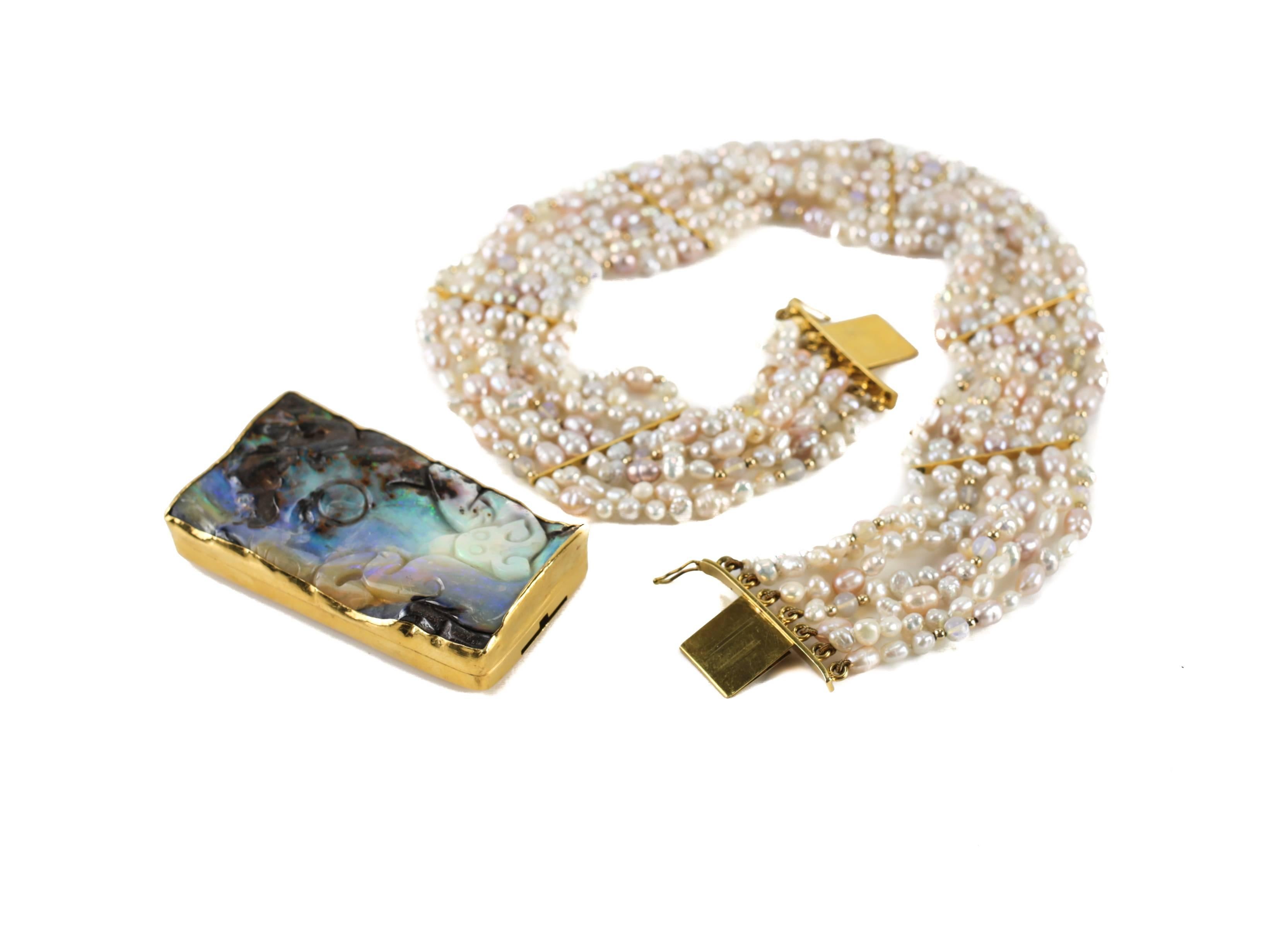 A substantial opal necklace by the late San Francisco based jeweler Harry Fireside. Featuring an extraordinary carved solid opal singlet with 24k yellow gold mounts and an 18-karat yellow gold back. The natural centre mounted opal with several