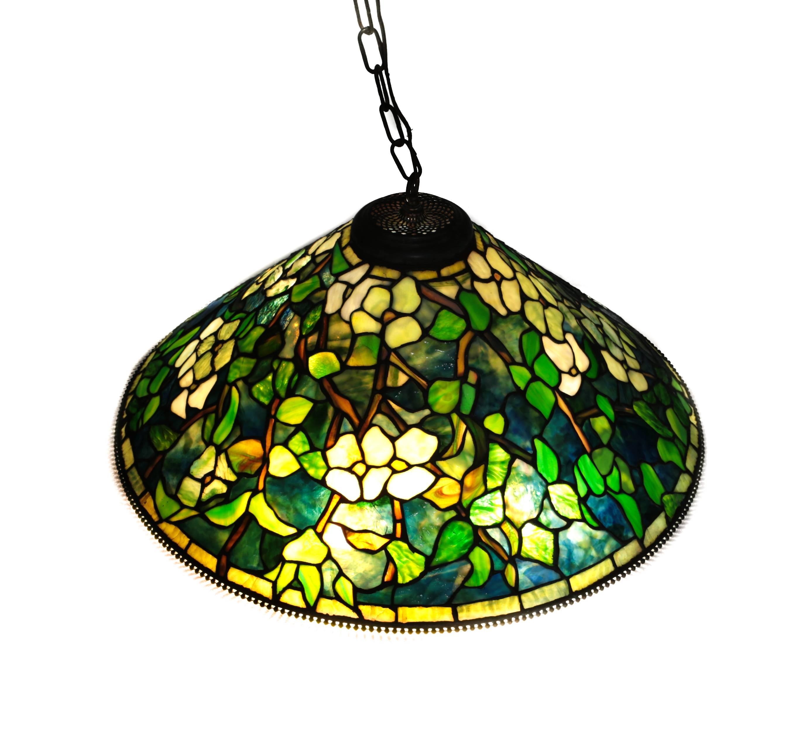 A large and stunning Tiffany Studios reproduction chandelier by Paul Crist Studios. Multicolored green stained glass mosaic designs. Bronze mounts, circa 1980.