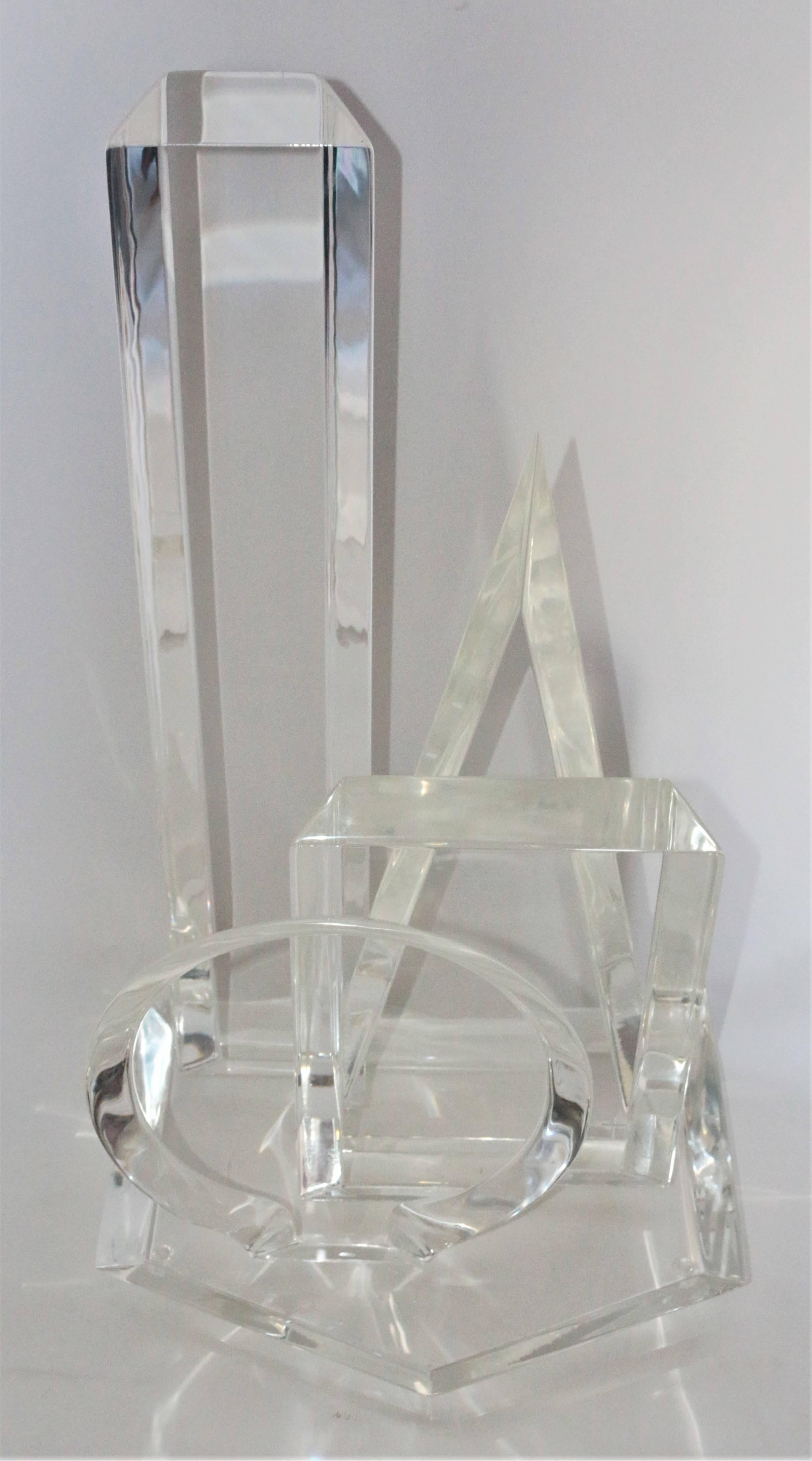 Mid-Century Modern 1963 original Van Teal acrylic Lucite sculpture signed. This sculpture has been molded to show a circle, square, triangle and rectangle. All shapes have beveled properties. The base is shaped like a Pentagon holding each