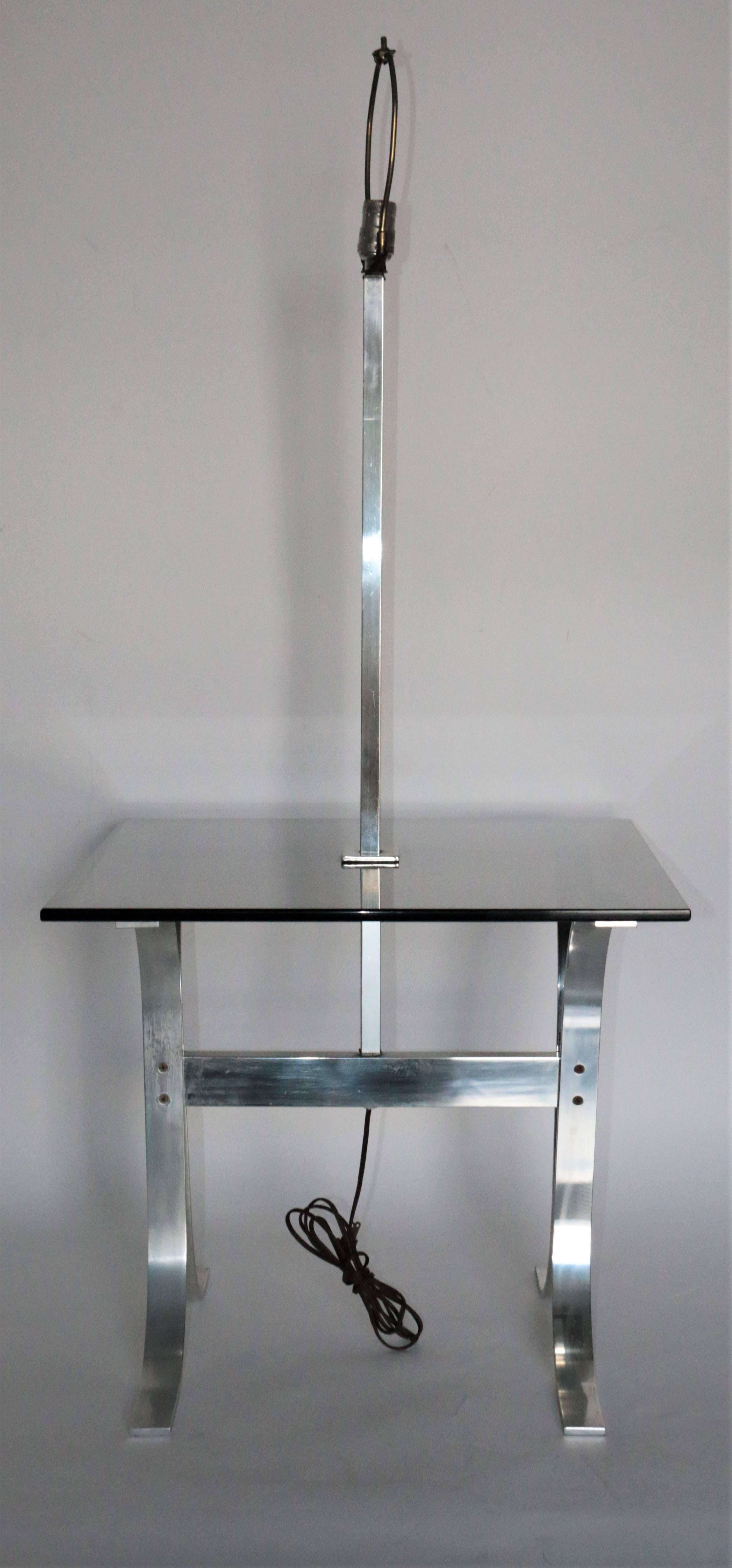 Mid-Century Modern side table with a built in lamp and tinted glass. Made of chrome.