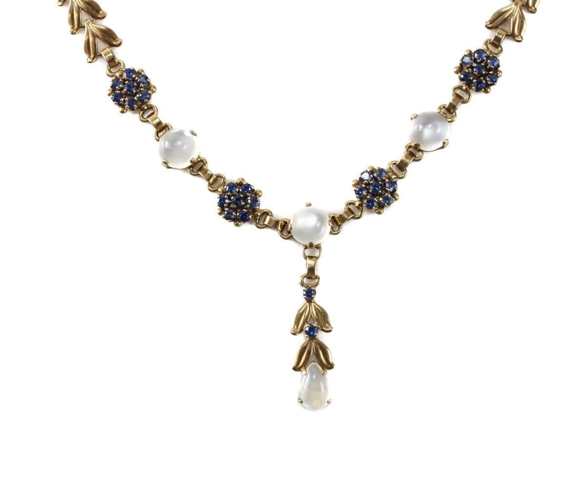 A stunning retro midcentury Tiffany & Co. 14-carat yellow gold moonstone and sapphire necklace choker. The fine leaf form linked necklace has four (3 round cut & one teardrop) cabochon moonstones with 30 round cut sapphire stones to the central