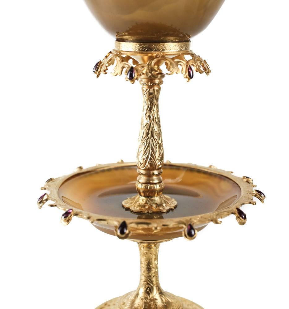 A charming continental gilt silver and agate mounted tazza with garnets, circa 1920. Incredibly fine quality agate carving, and deep ornate hand engraving to the gilt areas. Beautiful teardrop/pear garnet stones to the rims along the tiers. The base