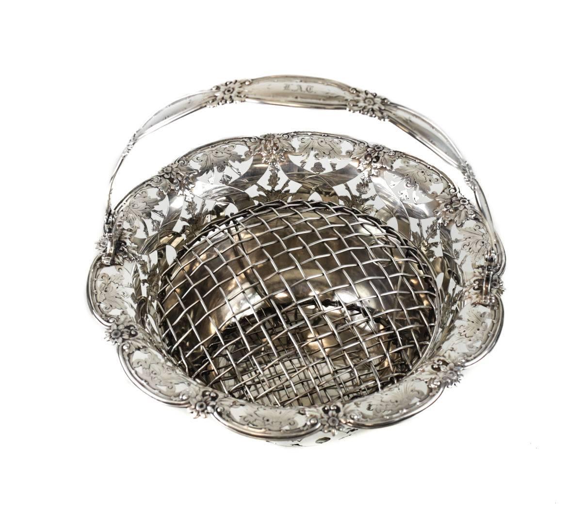 Tiffany & Co makers sterling silver flower basket #16201, John C. Moore. Beautiful open work hand chased florals throughout the interior of the basket and handle. Monogrammed 