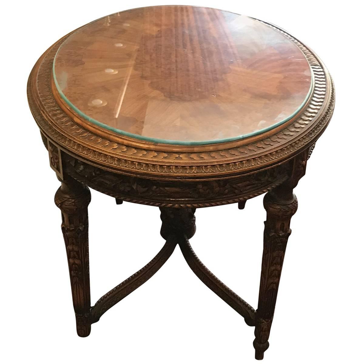 Scholle Furniture Co. was a Chicago-based manufacturer of fine furnishings. Sleek and elegant, this neoclassical-style occasional table is crafted from walnut and features hand-carved inlay. Four shapely legs and stretchers give this eye-catching