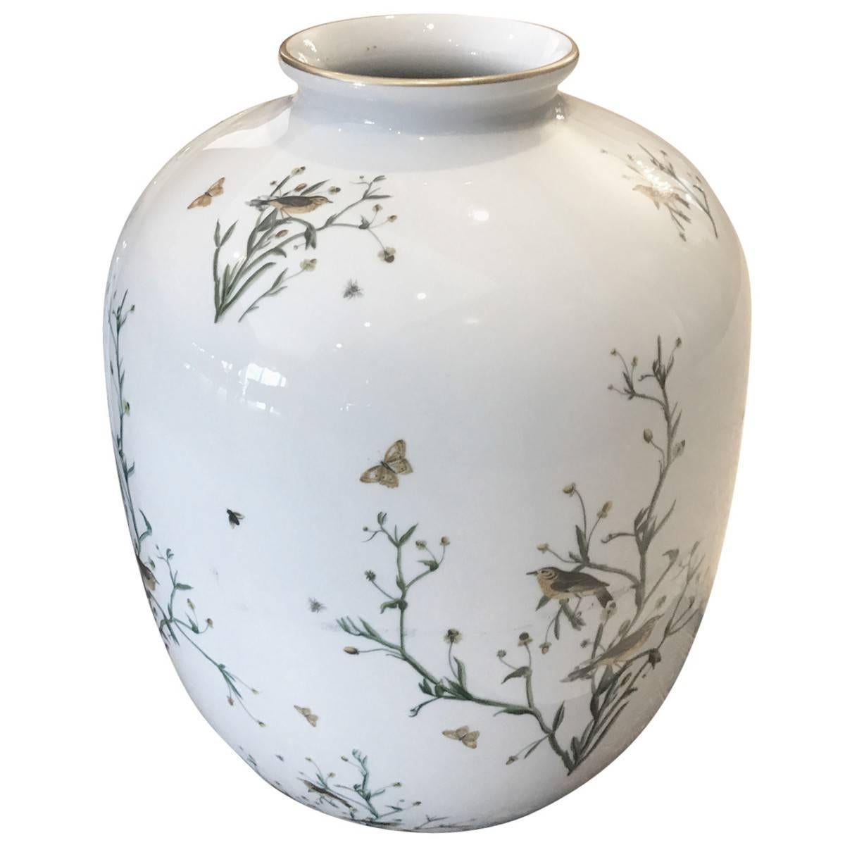 Pair of antique Rosenthal vases. Rosenthal is a leading distributer of fine china and glassware. Sleek and sculptural, this stunning pair of porcelain vases is decorated with songbirds, plants, and butterflies. Maker’s marks ensure authenticity,