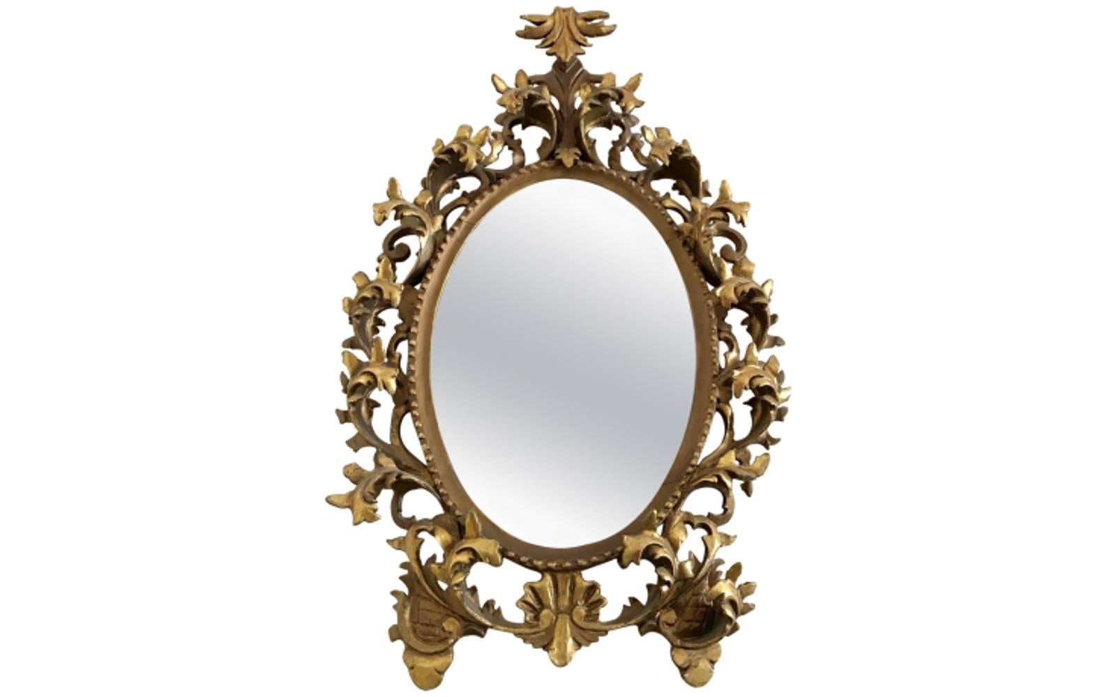 Pair of French Monumental Rococo gilded mirrors.
 This elegant pair of oval mirrors features elaborately scrolled giltwood and gesso frames. These eye-catching accessories make a lavish statement in any space.