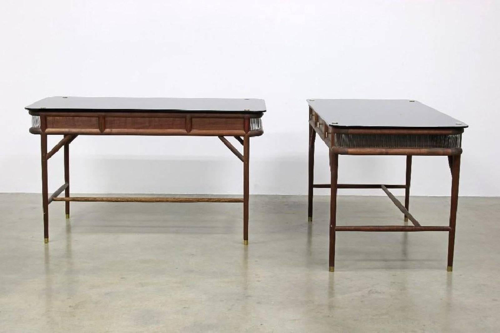 Pair of modern Westin Mitchell 'Parlor' desks. Walnut, polished brass, smoked glass and inlaid glass rods. Measures 55 1/4 L x 28 3/8 D x 31 1/2 H.
    