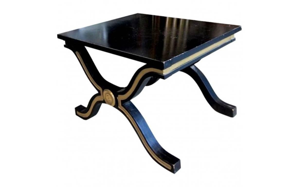 Dorothy Draper & Company is America's first and most acclaimed design firm. Sleek and sophisticated, this eye-catching pair of side tables is made of ebonized wood and features brass legs. Handmade in the 1950s for Heritage, these gold leaf-accented