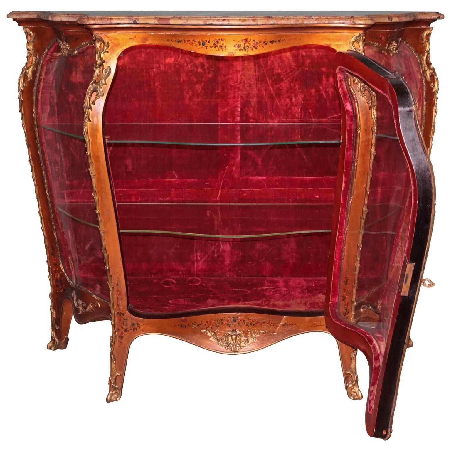 19th century French hand-painted vitrine cabinet with ormolu bronze. Breche marble-top with serpentine shape glass doors. The central door locking mechanism is all original and untouched. The door opens to an interior with two glass shelves with a