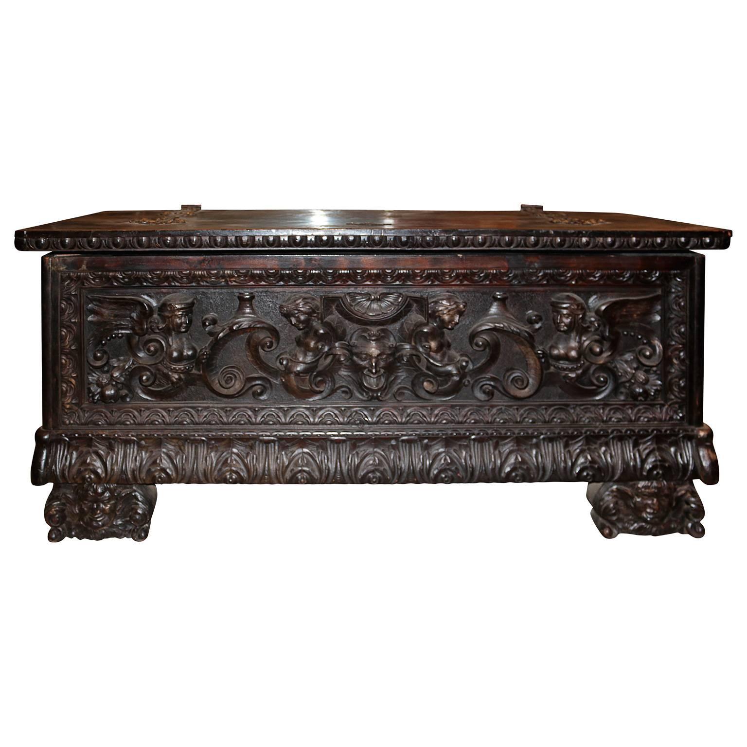 English 19th Century Baroque Heavily Carved Trunk with Hand-Forged Iron