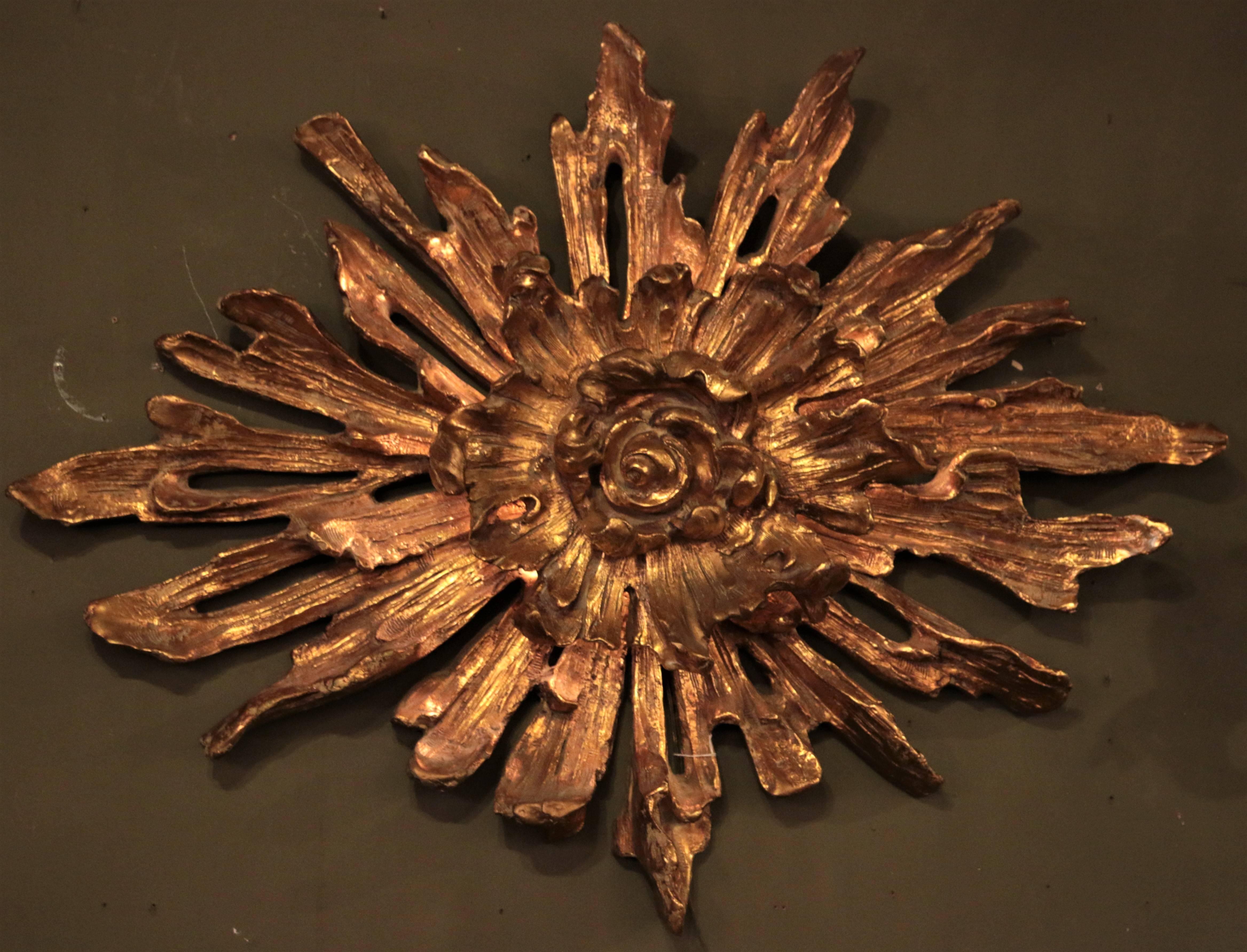 This beautiful sunburst wall-mounted light is truly a beautiful centrepiece. The beautiful glow of this wall-mounted light contours the rose burst from centre to tips where the glow extends into the room, lighting the surrounding areas with a golden