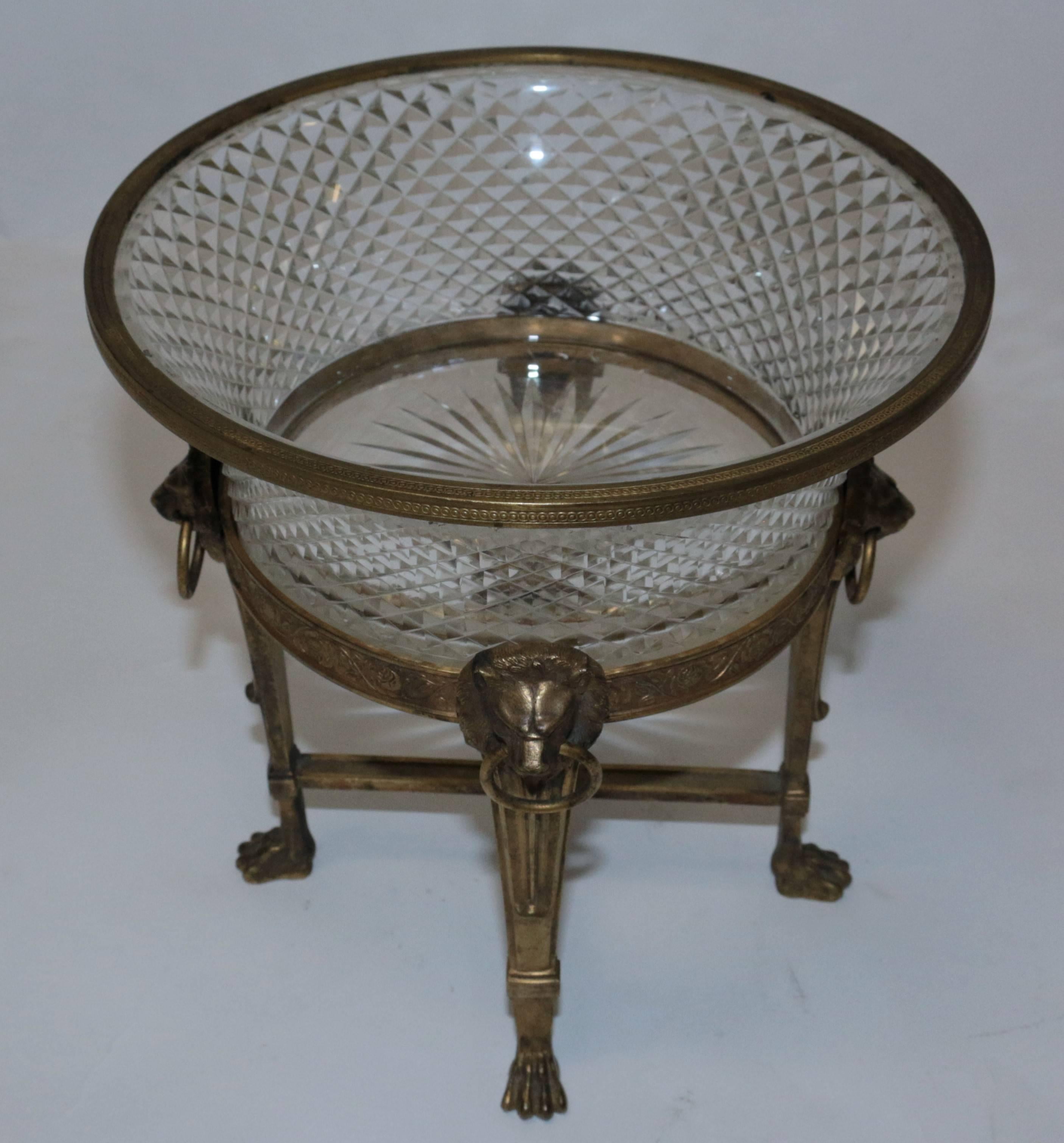 A wonderful 19th century antique French doré that has diamond cut crystal with gilt bronze ormolu frame. There are four lion heads around the center bronze rim of the centerpiece holding circular bronze rings.