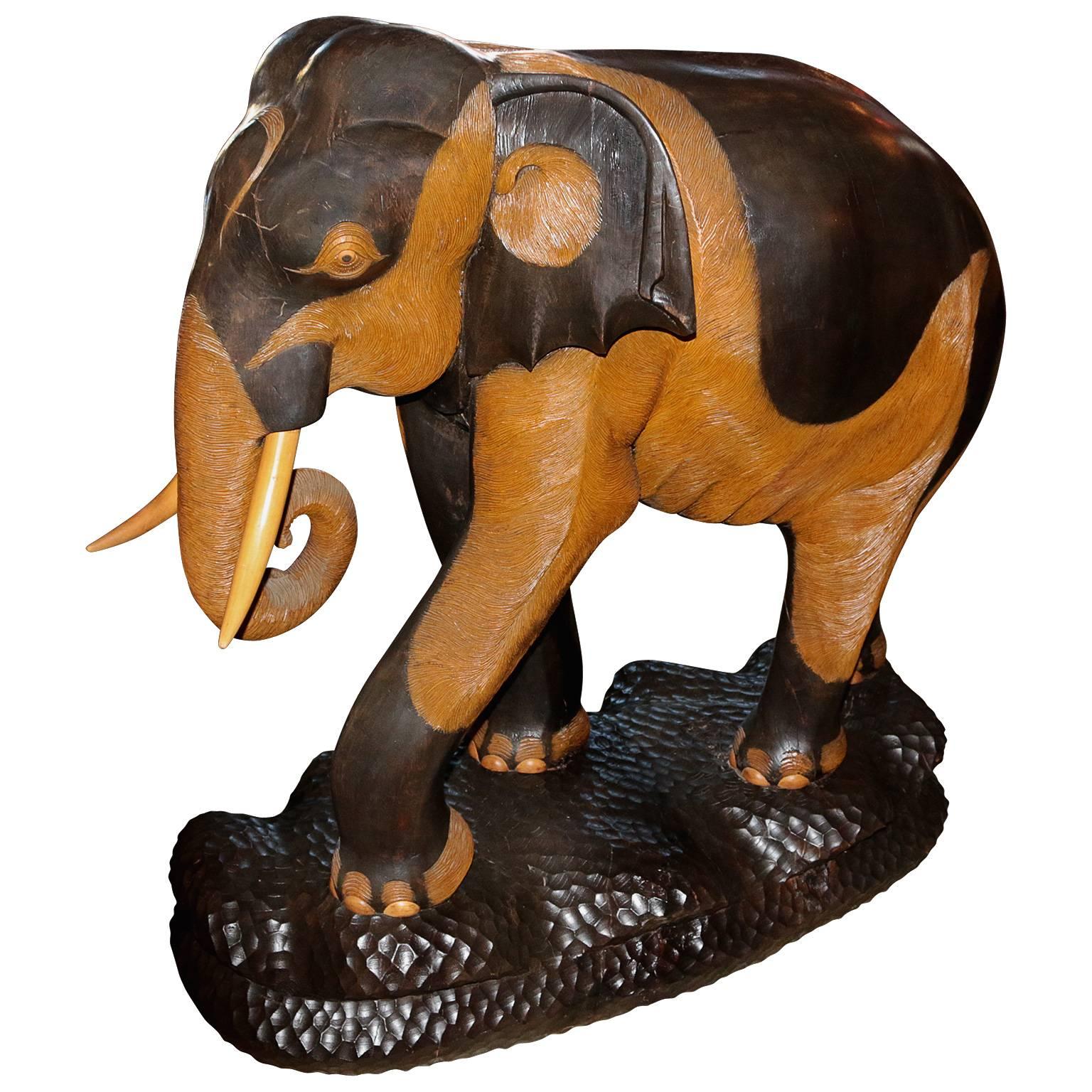 Hand-carved and painted mahogany elephant with life-sized features. Each part of the elephant has tremendous attention to detail. From the legs up, the ruffles on the skin of the elephant follow throughout the entire body. The attention given to the