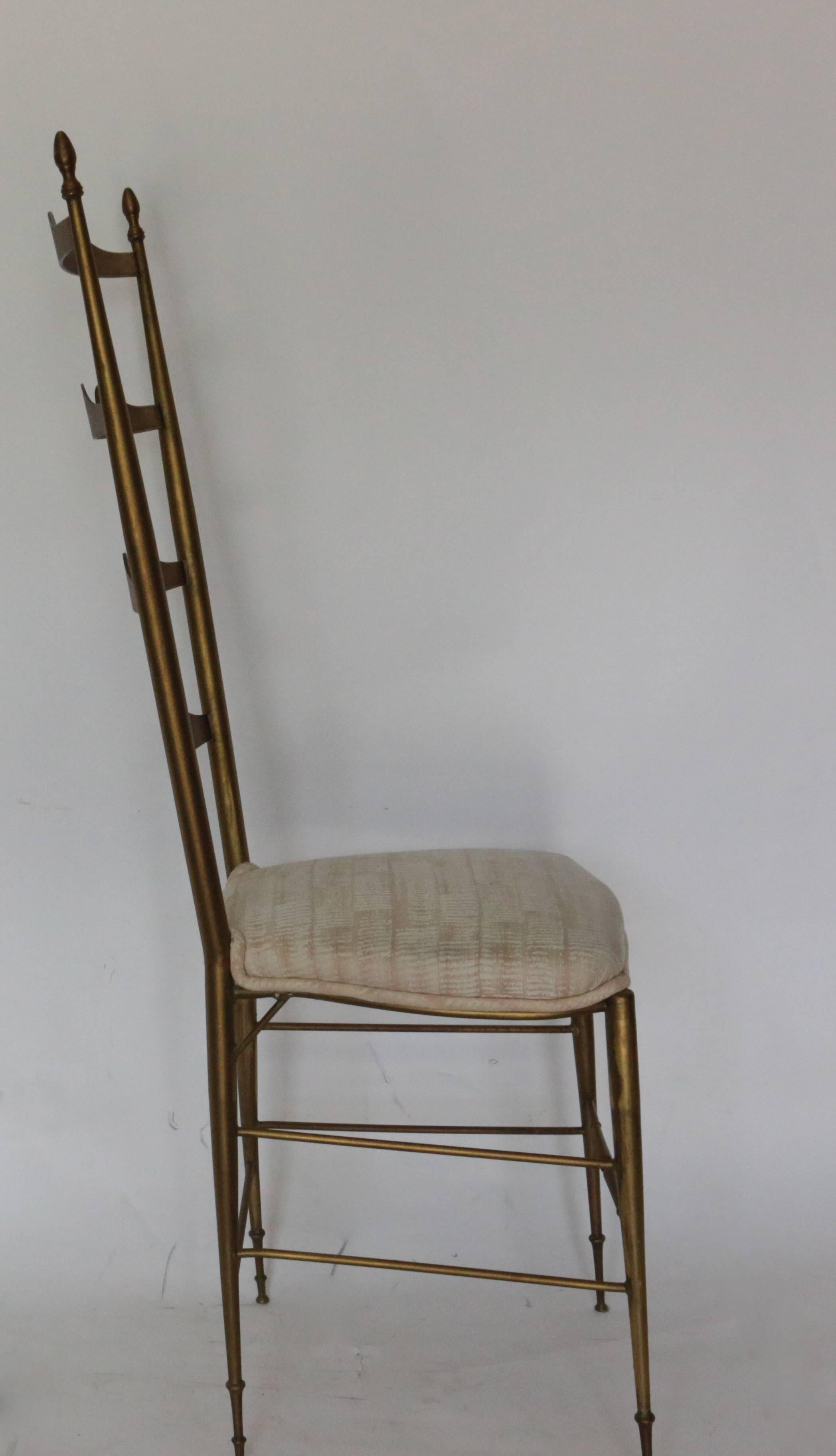 An elegant ladder back brass original Chiavari chair covered with imported fabric. In excellent used condition.
