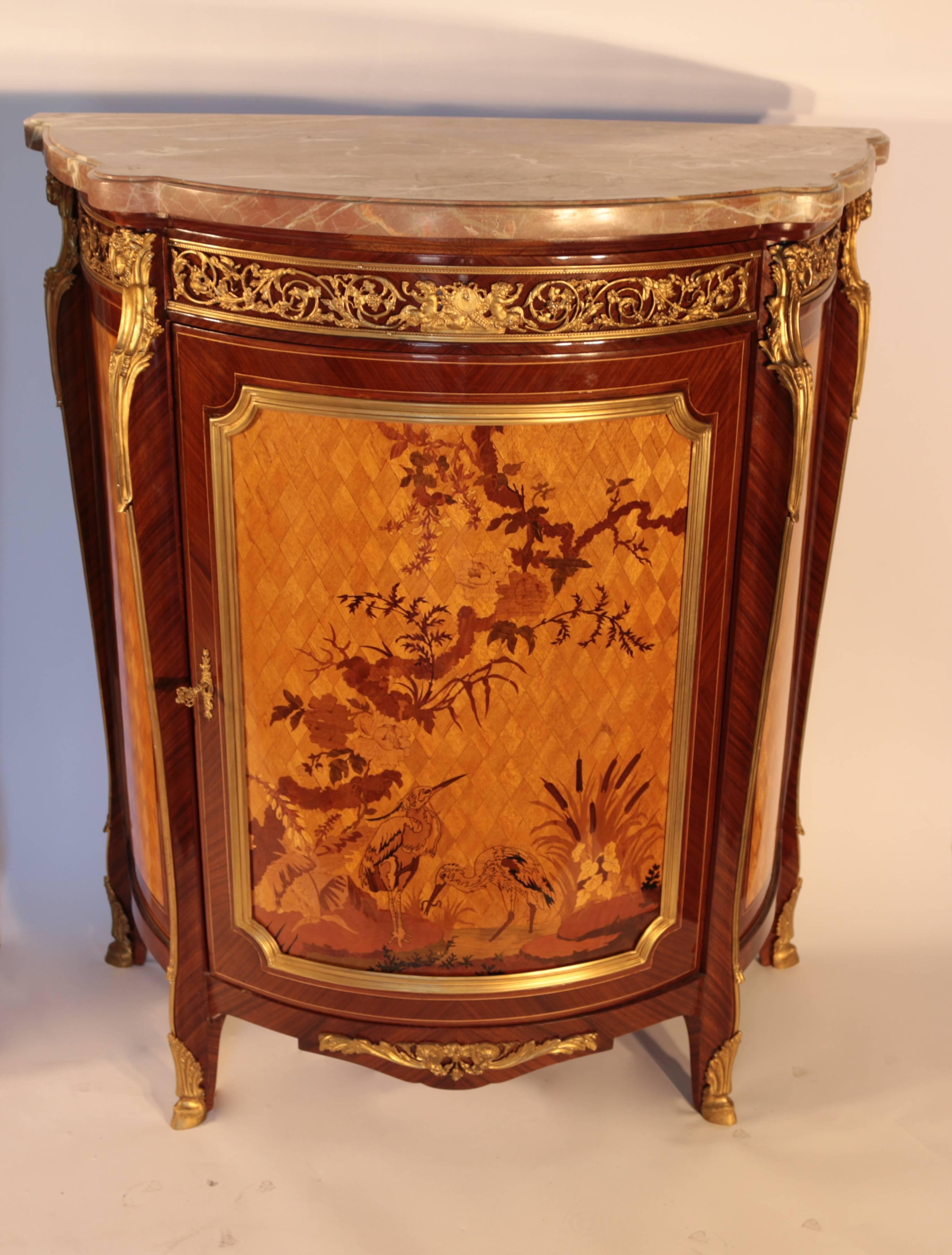Pair of elegant French style marble-top demilune cabinets with excellent ormolu-mounted to bronze with highly detailed inlay Francois Linke quality.
In excellent used condition.
    
