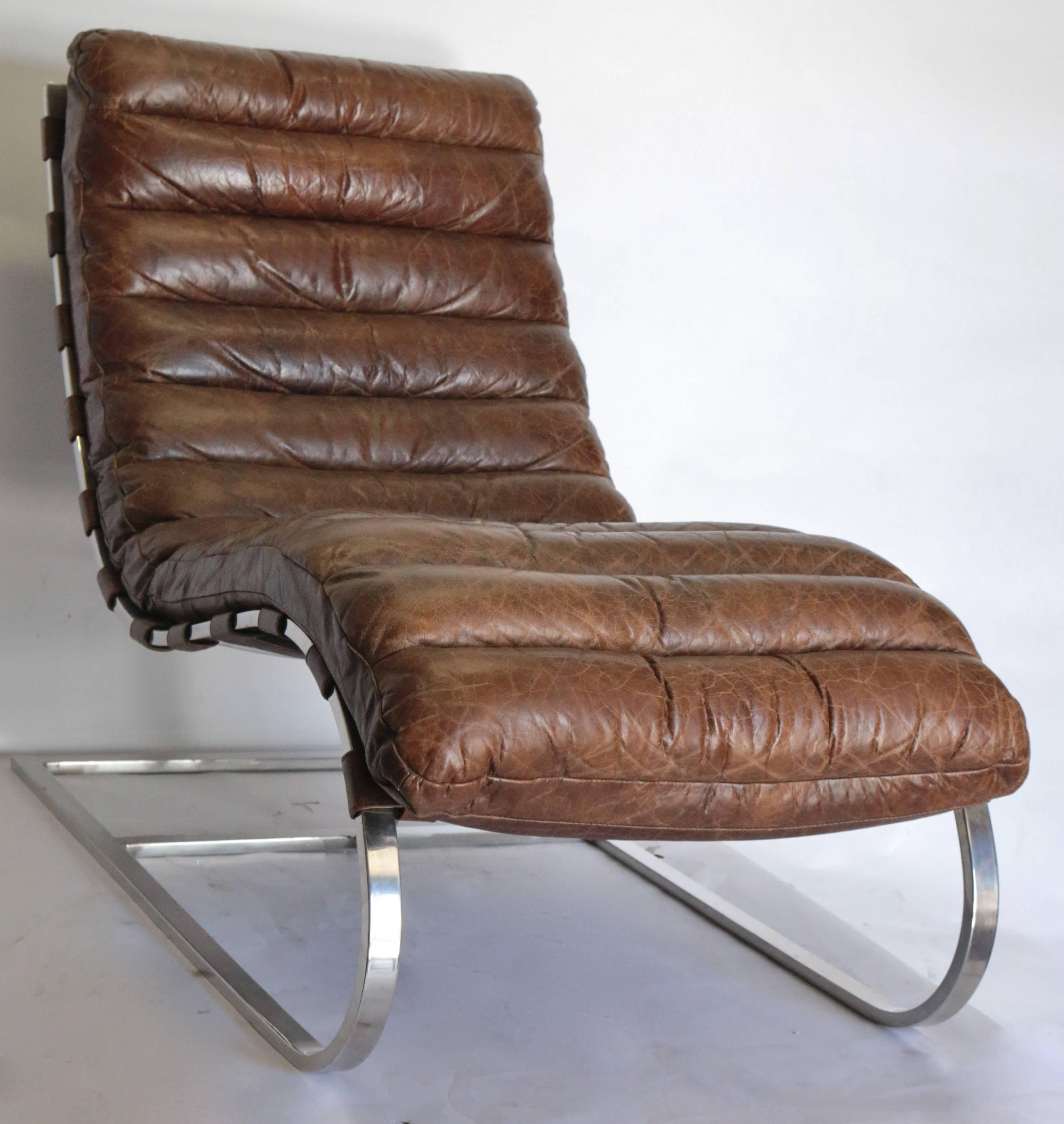 Iconic chaise lounge chair from the 1970s combines chrome and tufted thick padded cushion combined for optimal comfort. Mid-Century French distressed tufted leather chaise longue chair with chrome base is in excellent used condition. This 1970s