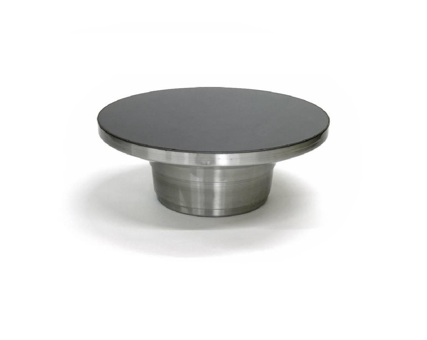 A stunning vintage contemporary aluminium round cocktail table with a black mirrored top, circa 1970.