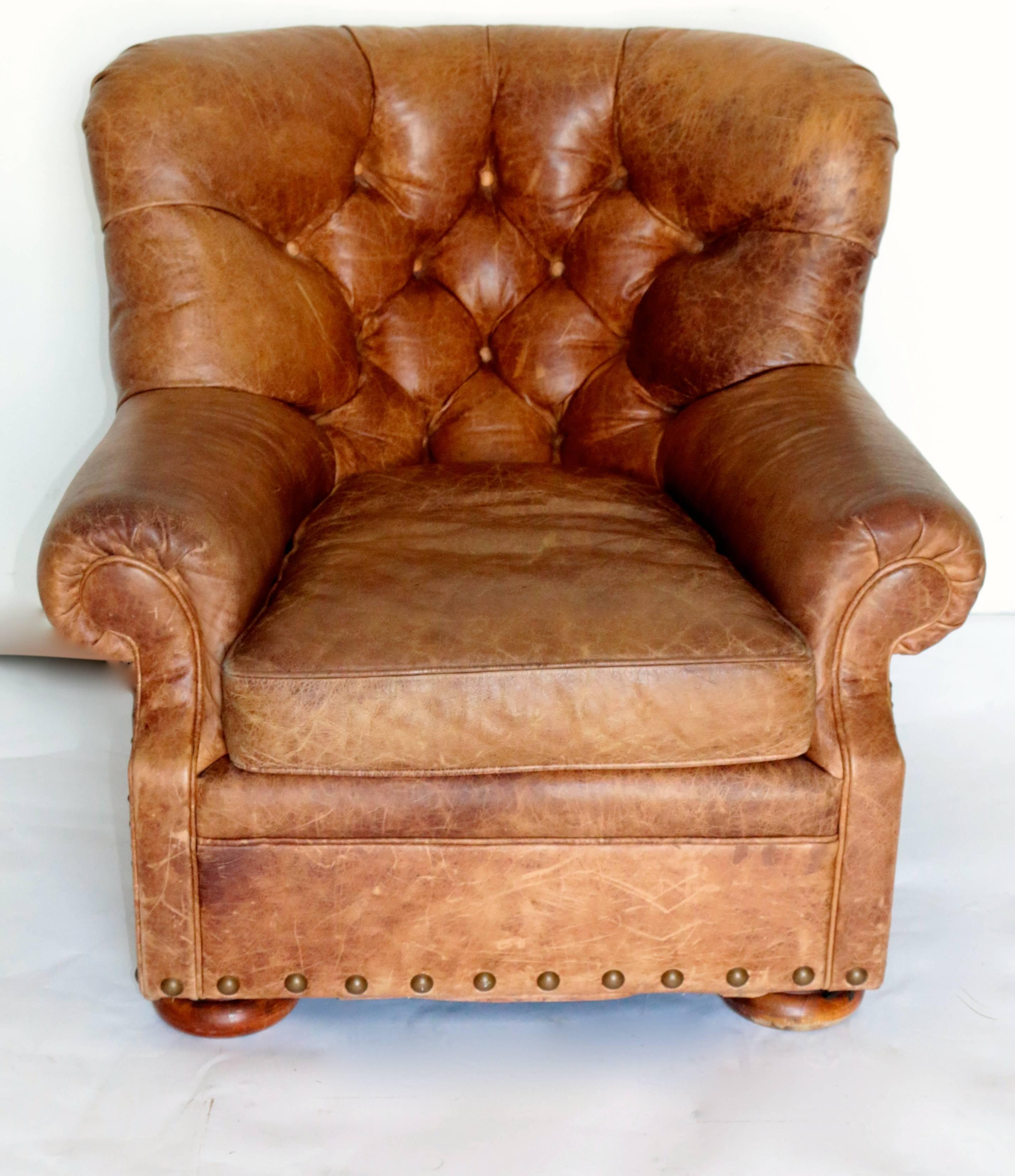 This iconic winged distressed club chair has a Classic tufted back and bun feet. This piece is distressed in excellent used condition due to age.

seat dimensions:

Height 17 inch
Depth 30 inches
Width 19 inches.