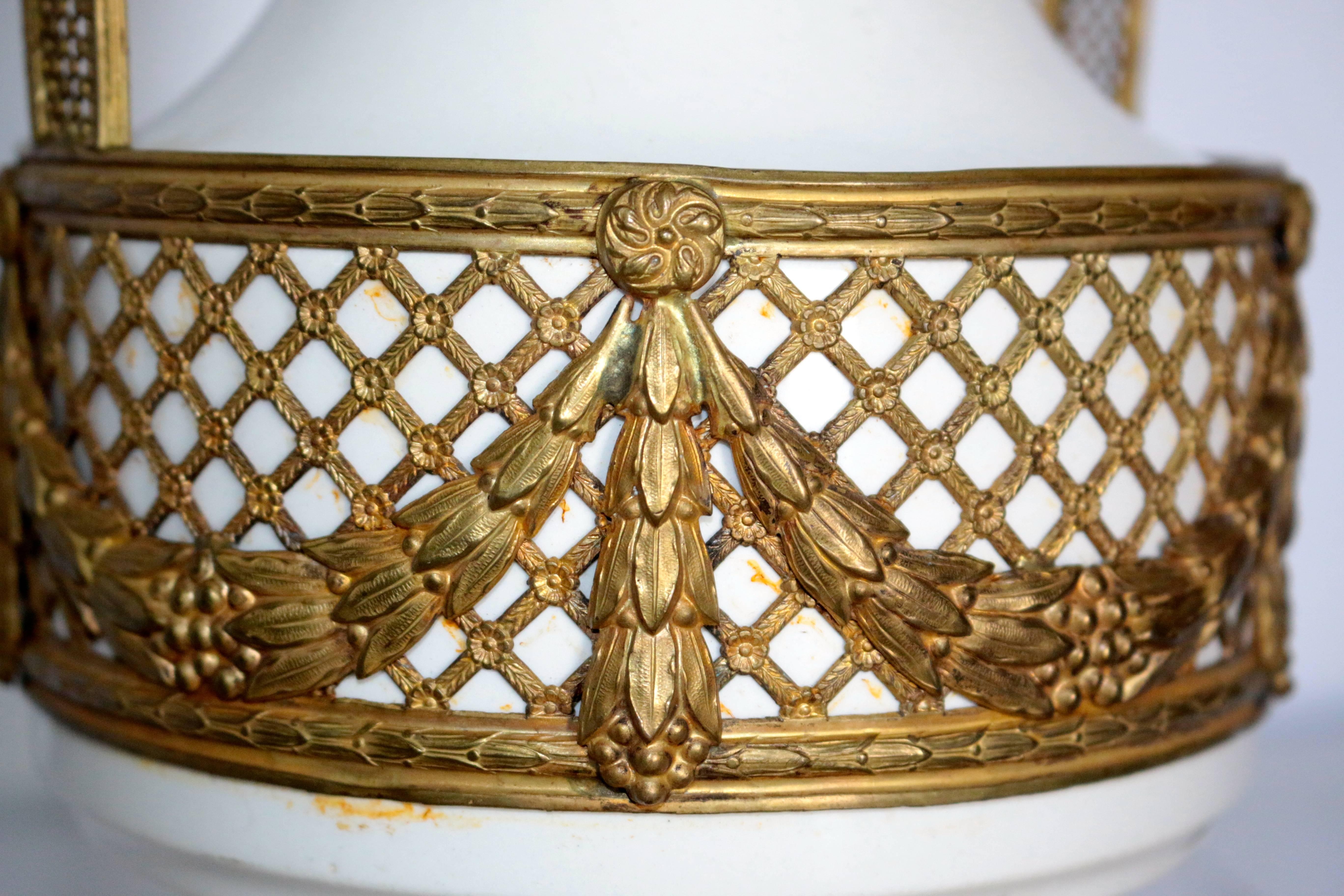 This Amazing 19th century French vase is stunning. The removable bronze trim has an intricate design that goes down to the smallest detail in the trim. From the ivy with the ribbons to the gilt frame fence. This beautiful vase can lighten up and