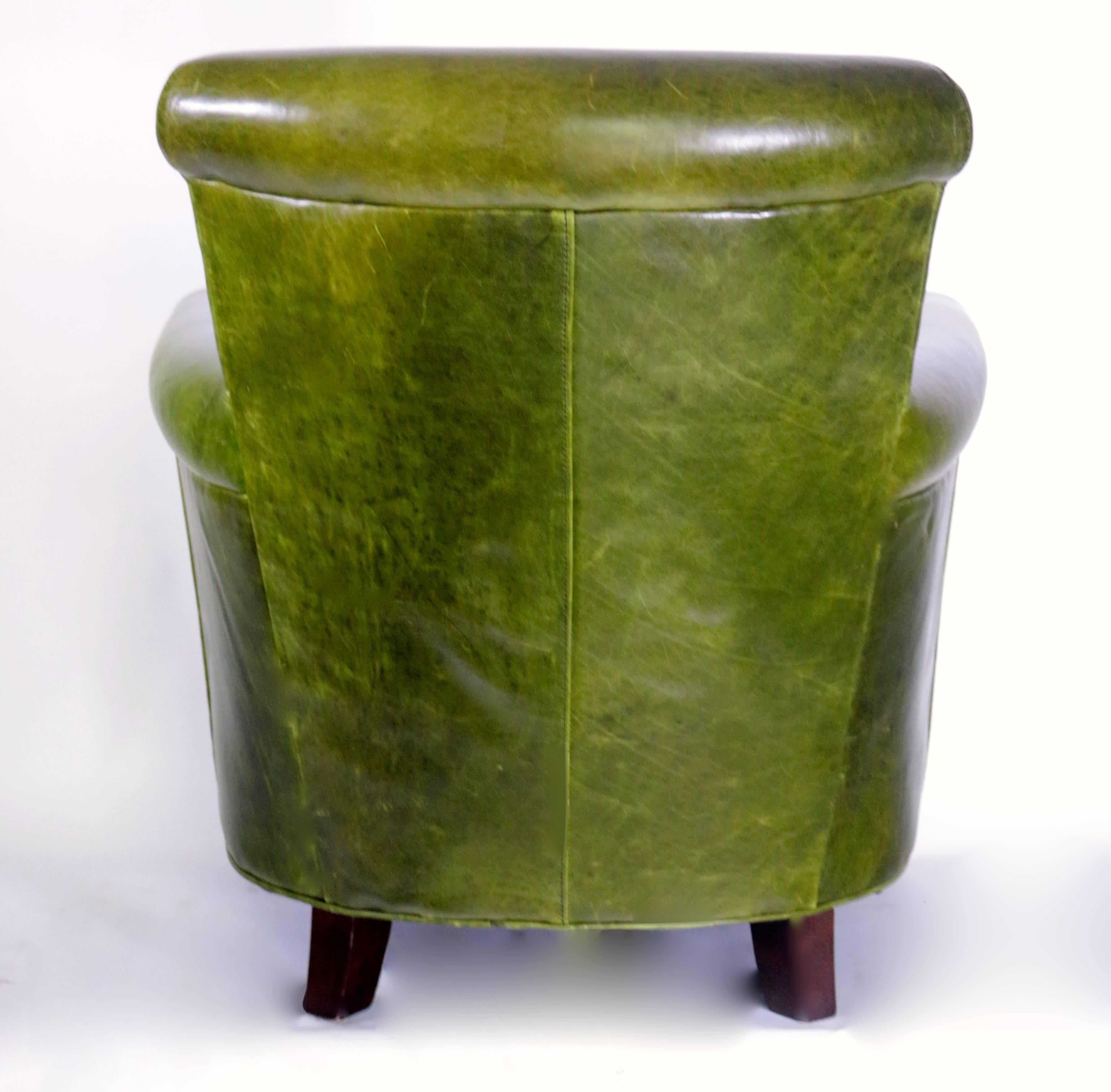 Beautiful distressed French green leather club chair in excellent used condition. This comfortable club chair is comfortable and practical. The distressed green is a dark and powerful tone. The inner width of the seat at its largest point is 23.5