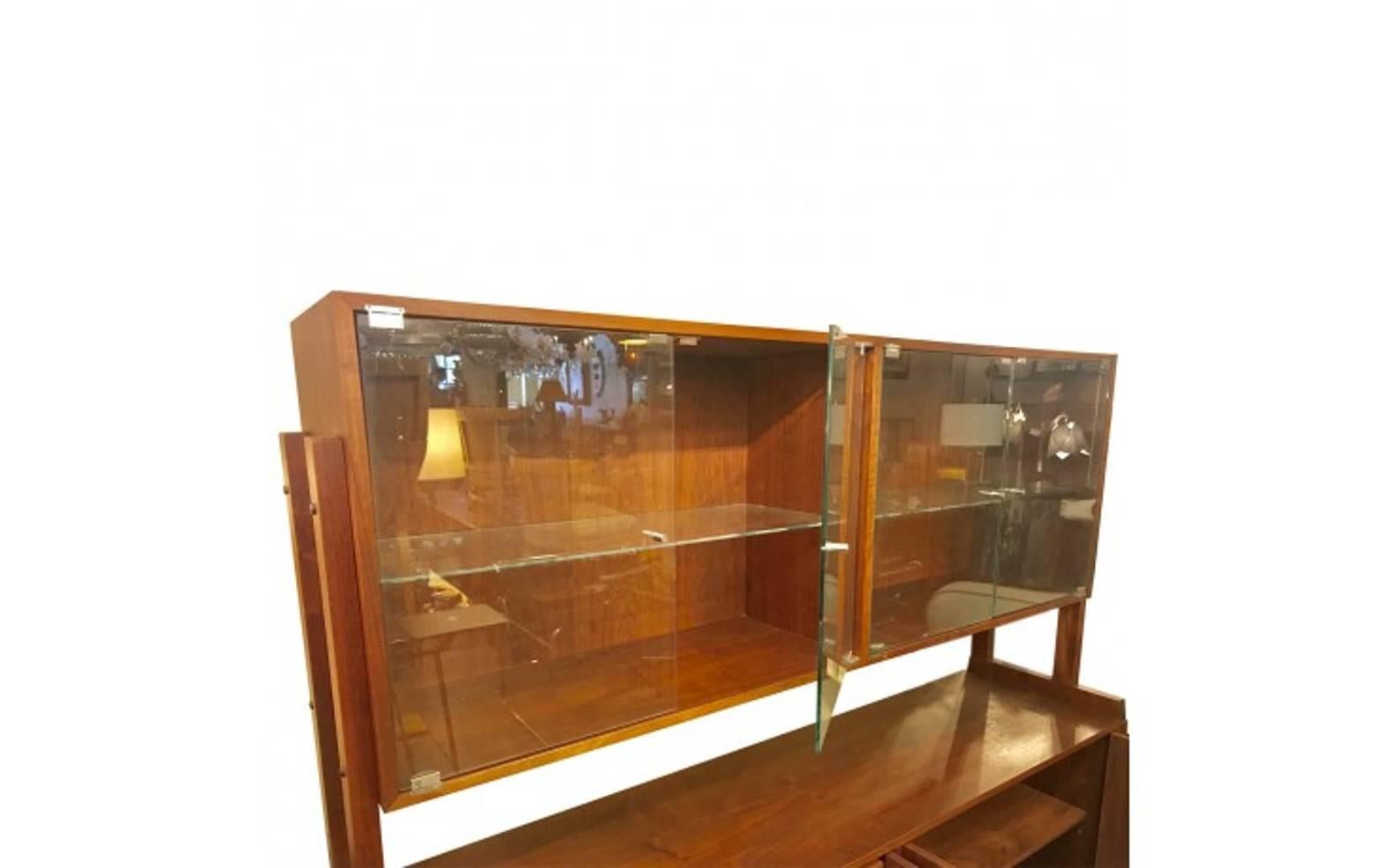 Mid-Century Modern Scandinavian sold teak credenza bookcase hutch with glass shelves and lower drawers in excellent used condition.
Centre section (open area): Height 12inches
Upper cabinet: Width 33 inches depth 14inches height 22inches
Lower