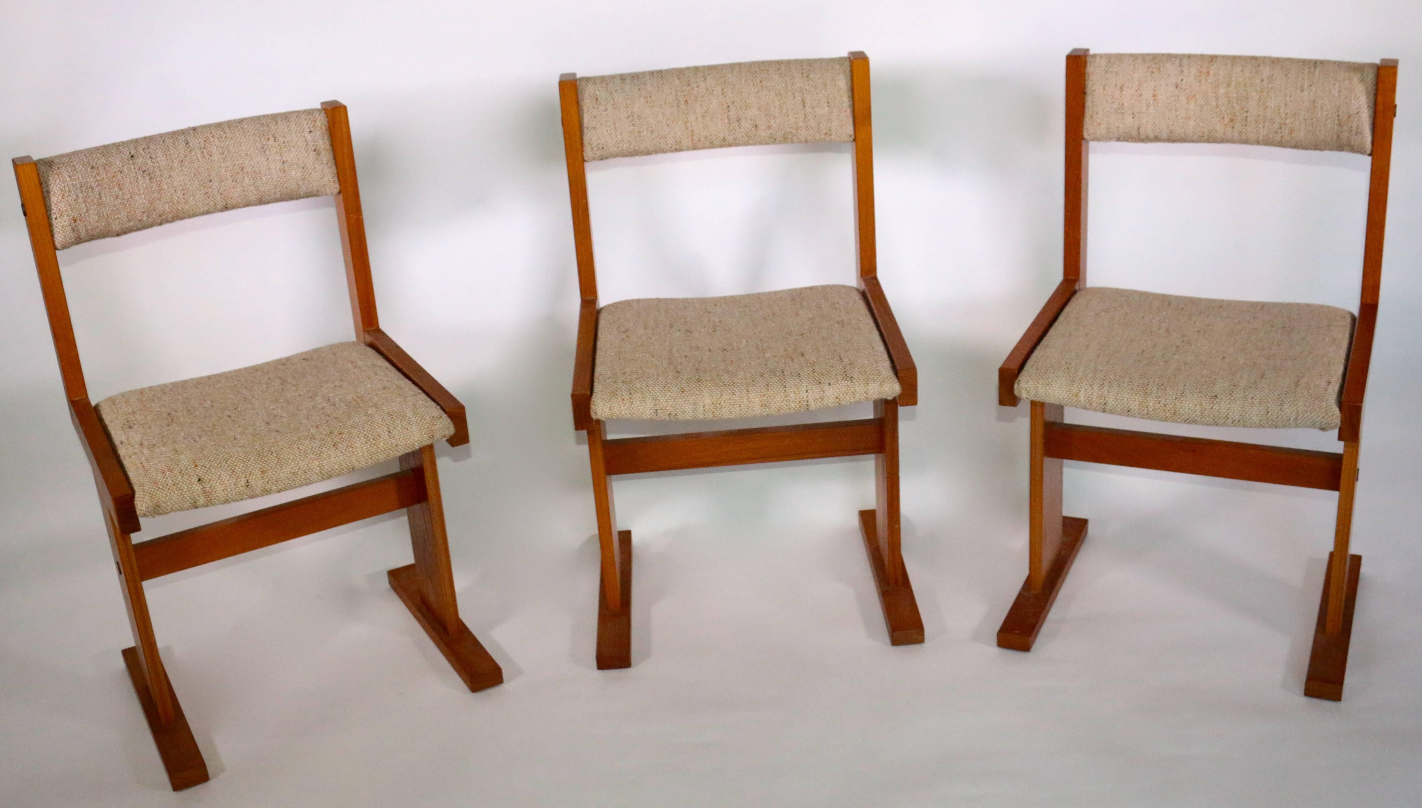 Crafted by Scandinavian Woodworks, these modern dining chairs were handcrafted during the 20th century with impeccable teak hardwood frames and textural linen upholstery. These chairs will instantly elevate any refined dining room décor. Sold in a