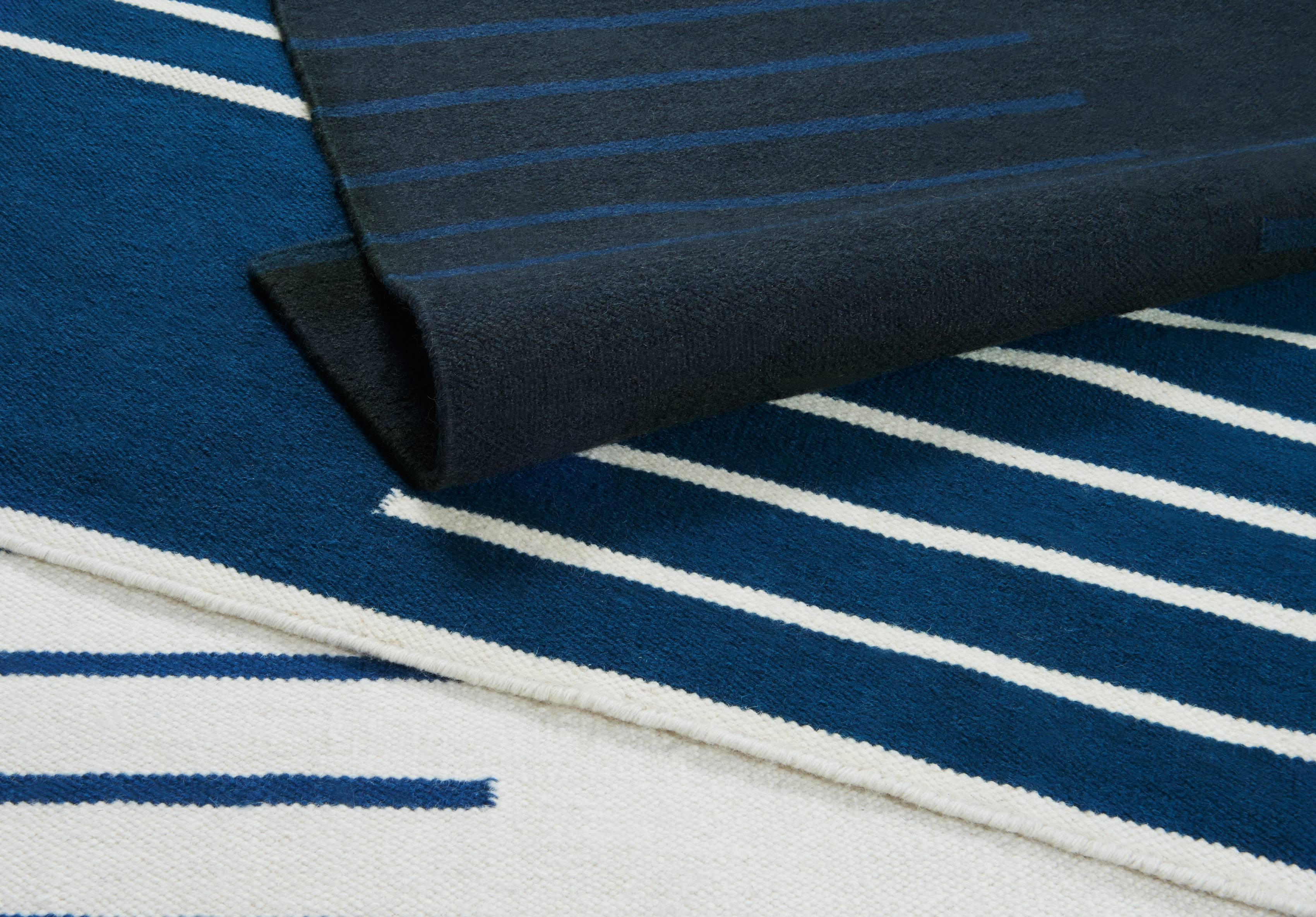 A modern dhurrie/kilim rug in Swedish design. Classic Blue/Cream in size 10'x14'. Also available in sizes: 2'5