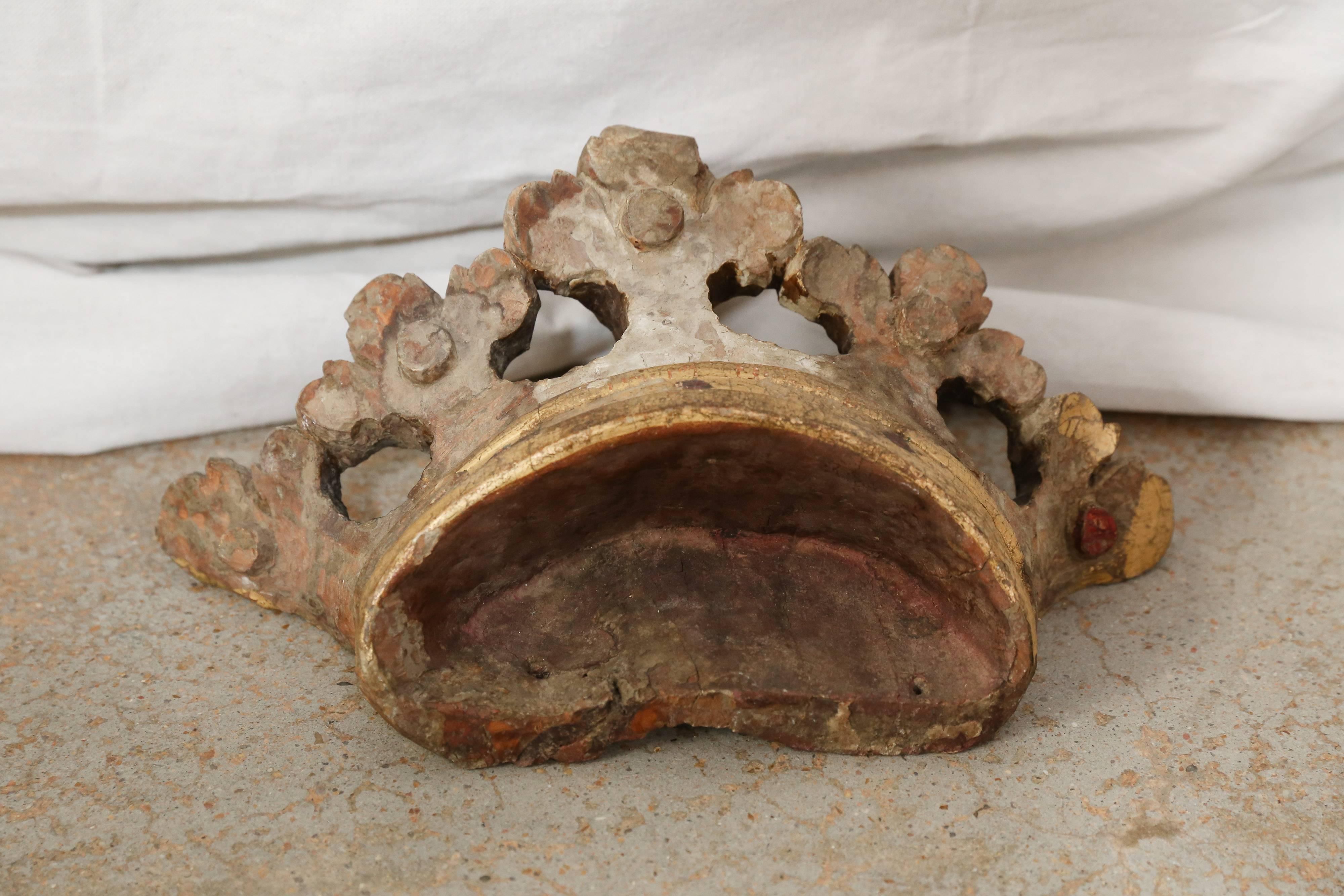 Remnants of gold paint with minimal detailing in red adorn this marvellous wooden fragment. Display on its own or utilize above a child's tester bed as a drapery crown.