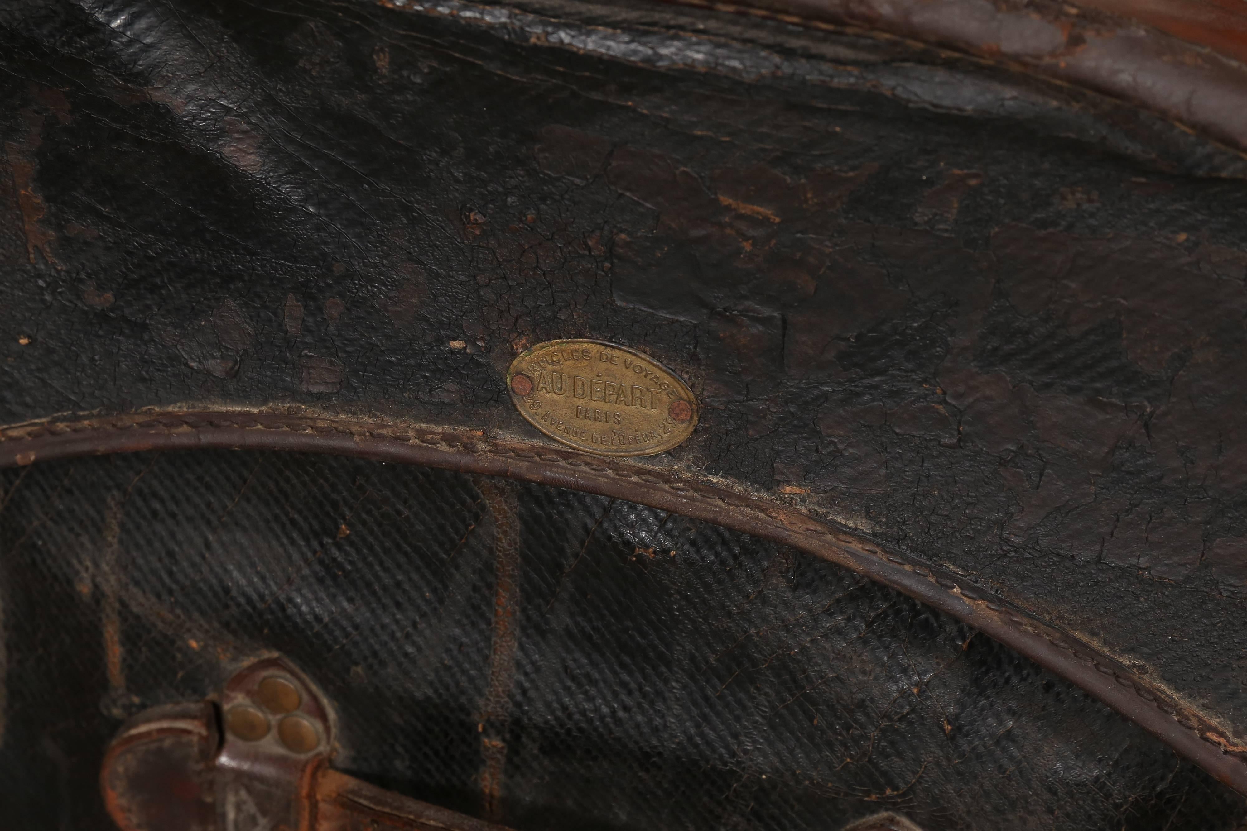 Founded in 1834, Au Depart is considered one of the four greatest French trunk makers. This handsome camel back trunk is superbly constructed of black vulcanized fabric on a woven frame with wood bracings, leather closures and handles attached with