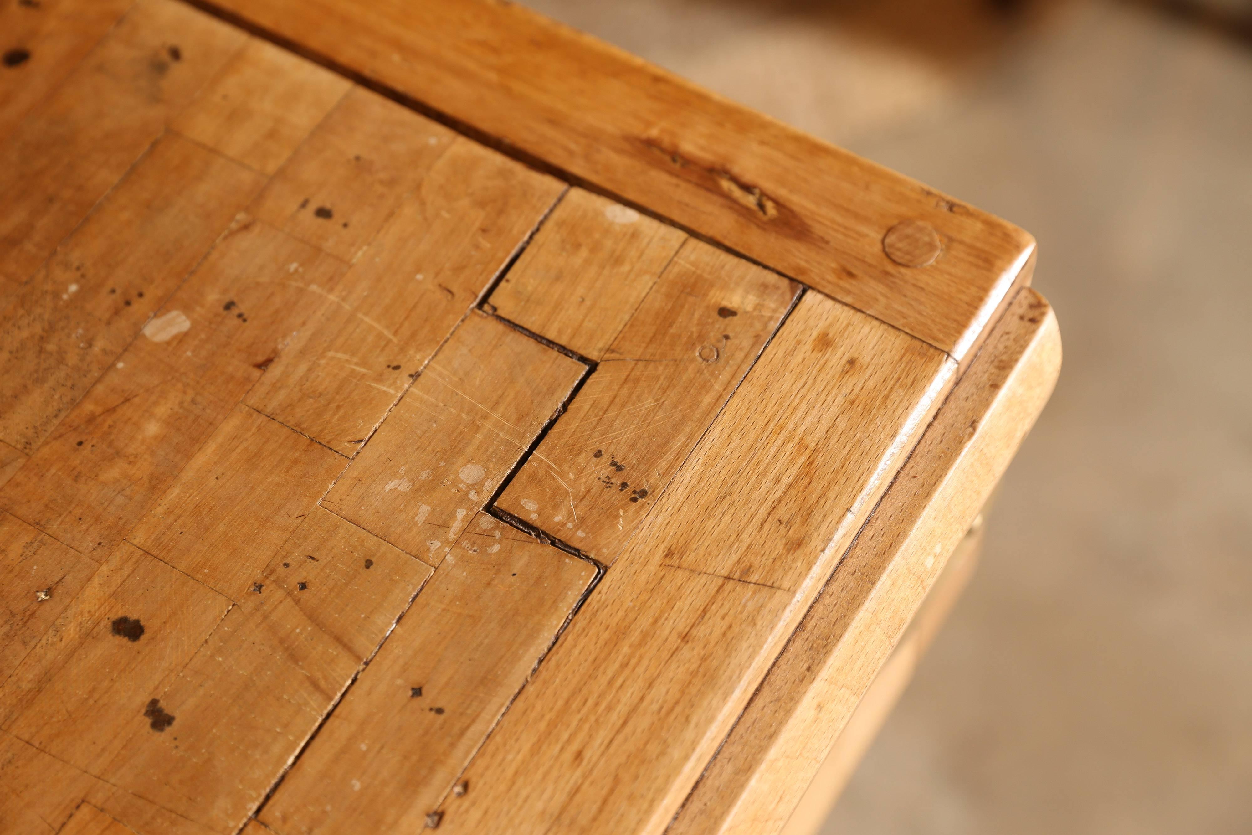 Wonderful maple butchers block from France with one large zinc-lined drawer. The gracefully shaped backsplash sports two handsome cast iron bulls heads while the corners are braced by brass brackets. Two brass details and a large brass ring