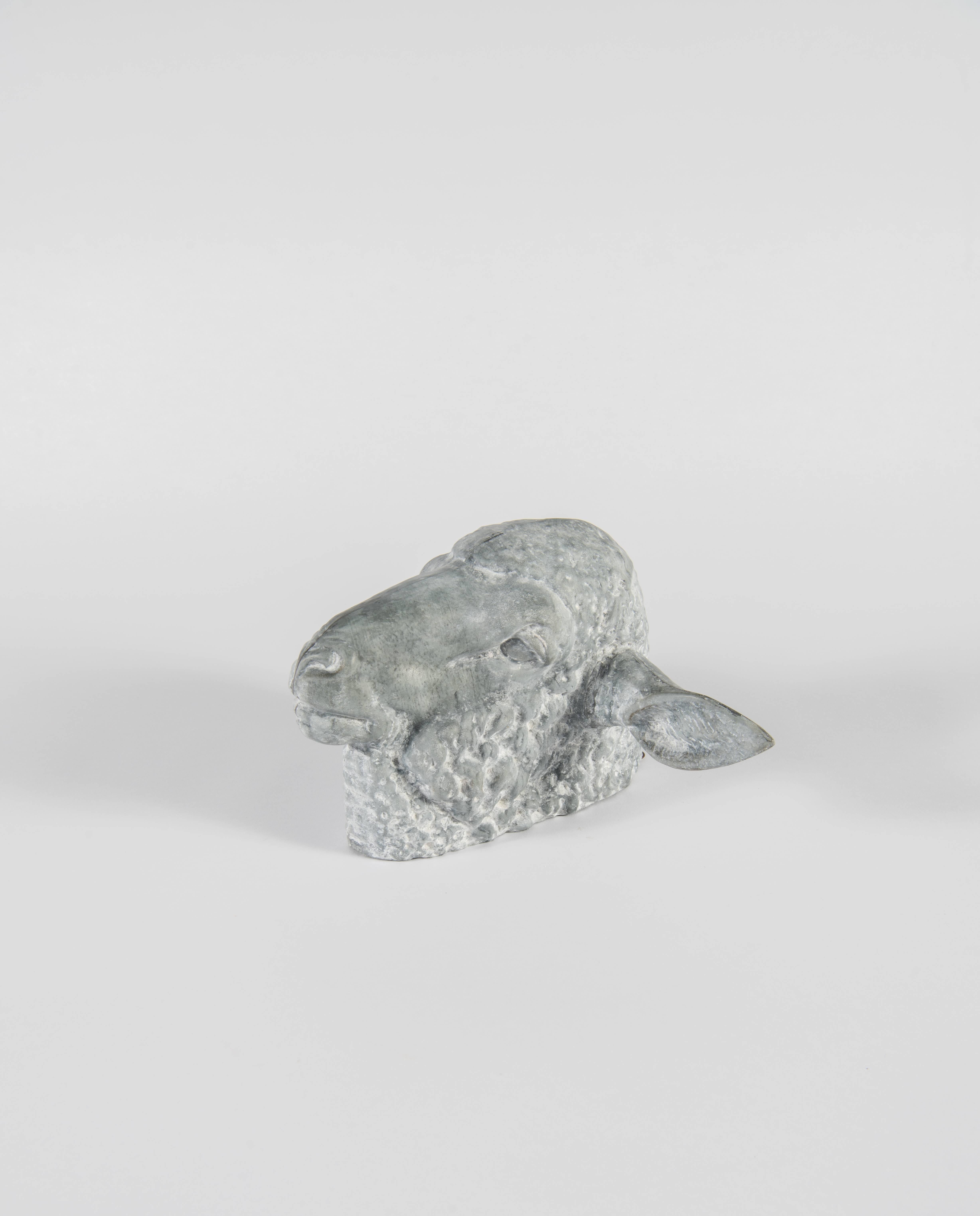 A hard-to-find zinc sheep's head with a nice dry whitish patina. Despite it's age, it is in very good condition and most likely never hung outside. The seams are sound and it has excellent detailing. With it's quirky ears and sweet face, it is a