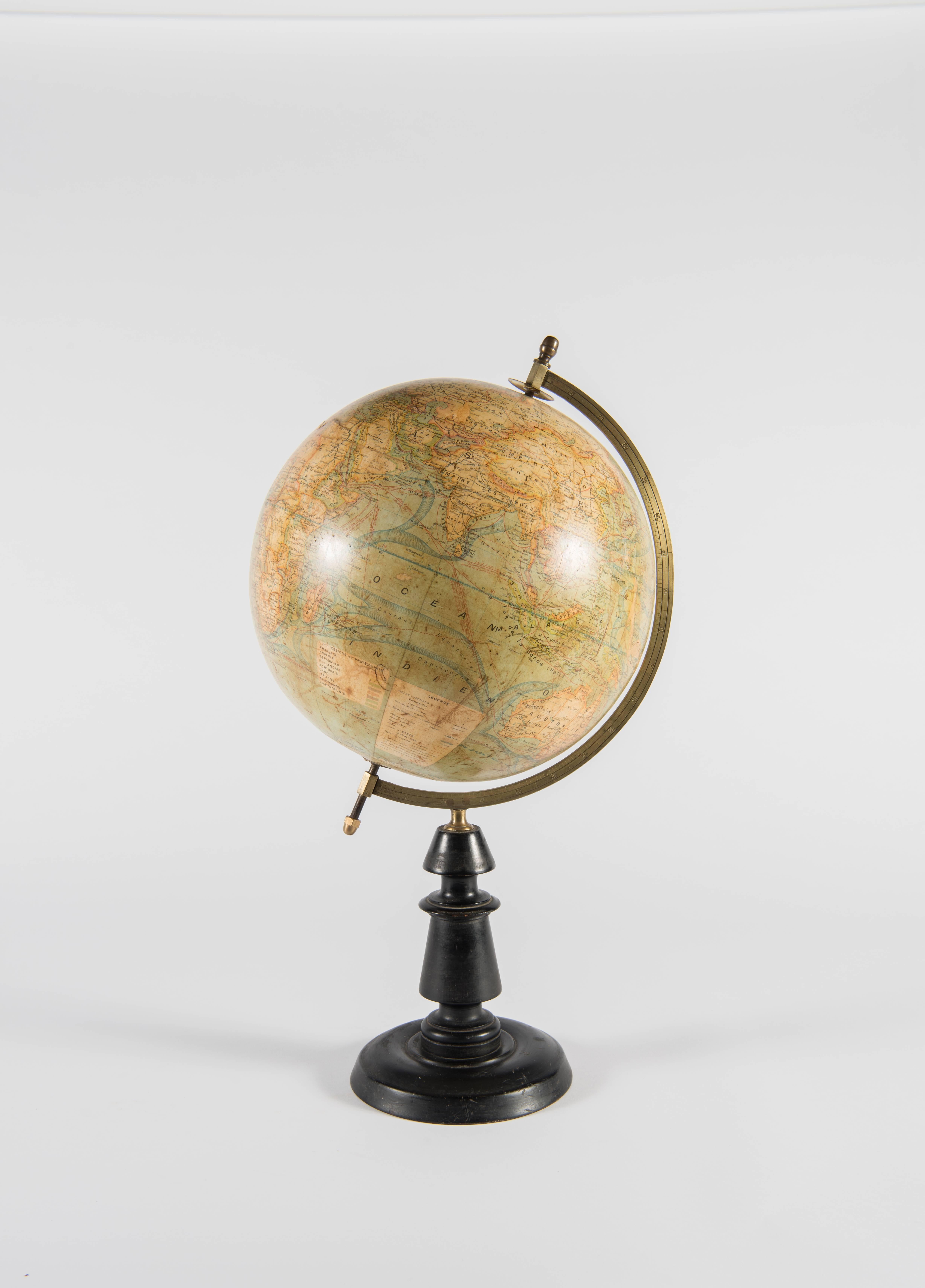 A French terrestrial globe, pre-1924, by J.Forest. The globe is mounted offset with a brass half meridian and is set on an ebony wooden Stand. Though it was produced during the golden era of the French Art Deco period, the stand is fairly