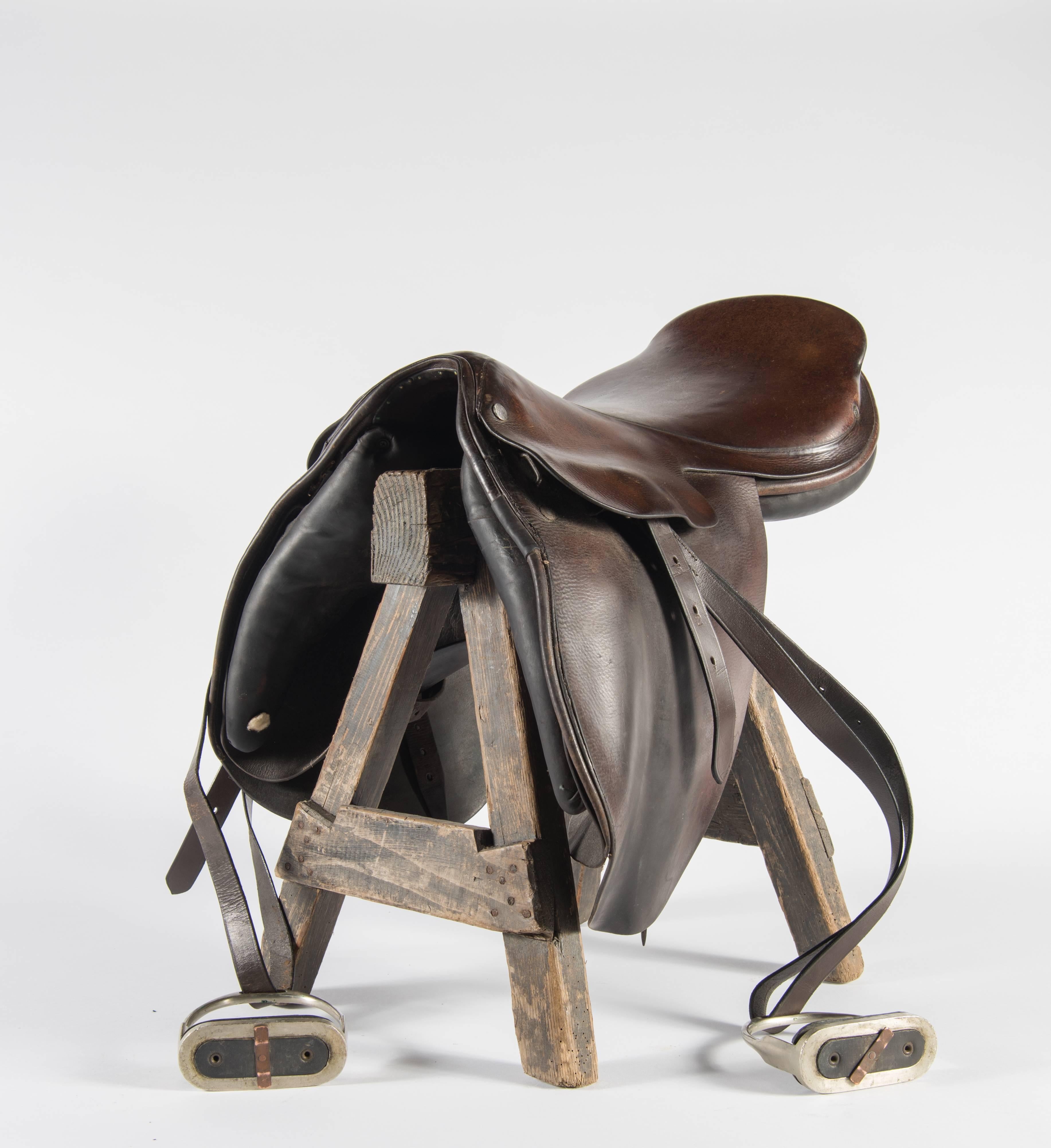 A vintage Hermès saddle from France. The leather shows use but is still in good condition on this handmade piece. With the Hermes name stamped on small metal brads, this piece speaks for itself.