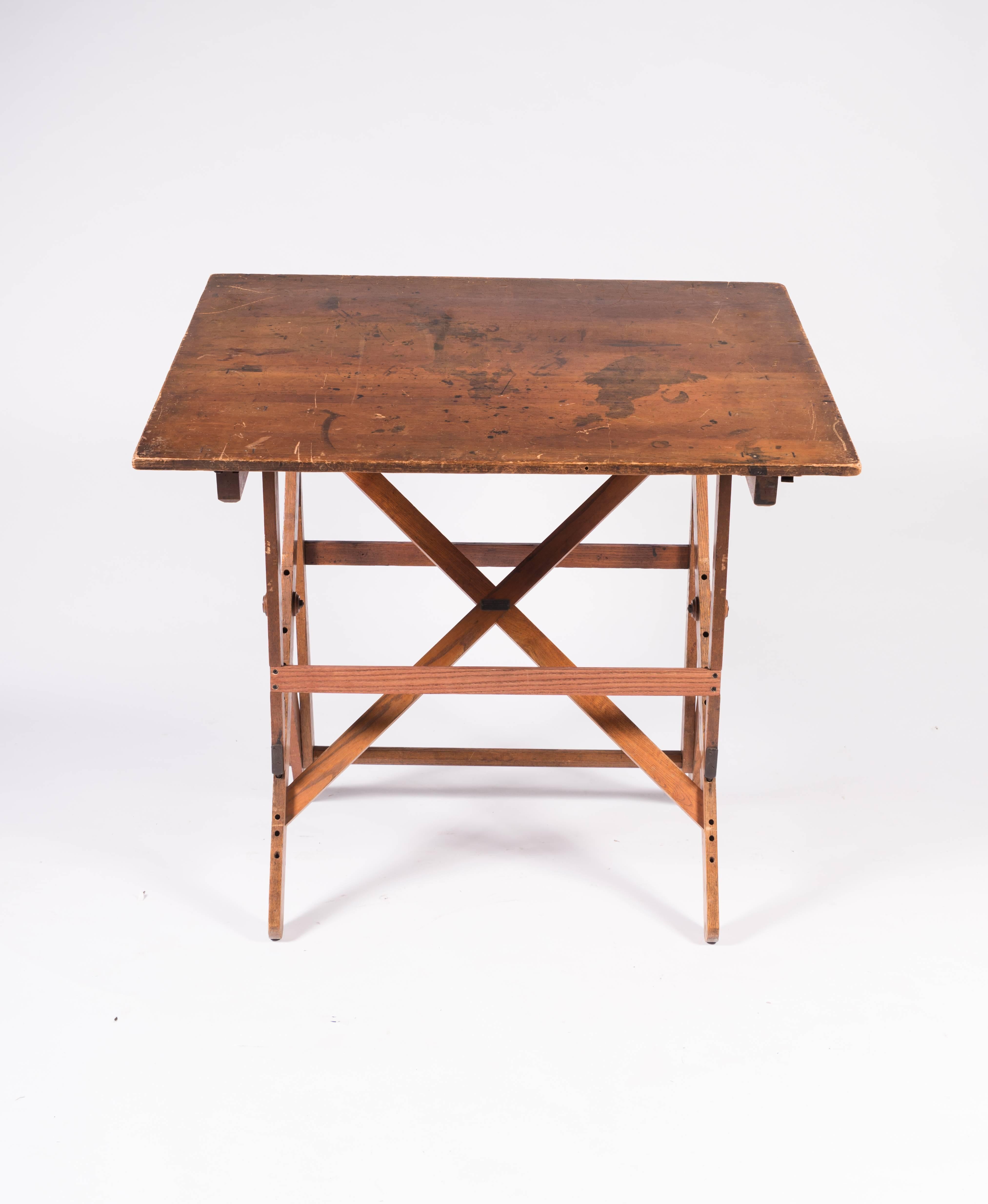 From Keuffel and Esser, America's first drafting table manufacturer, a vintage drafting table that tells the story of its past and its intentions for the future on its beautifully worn and ink stained work surface. Sturdy and solid, it adjusts from