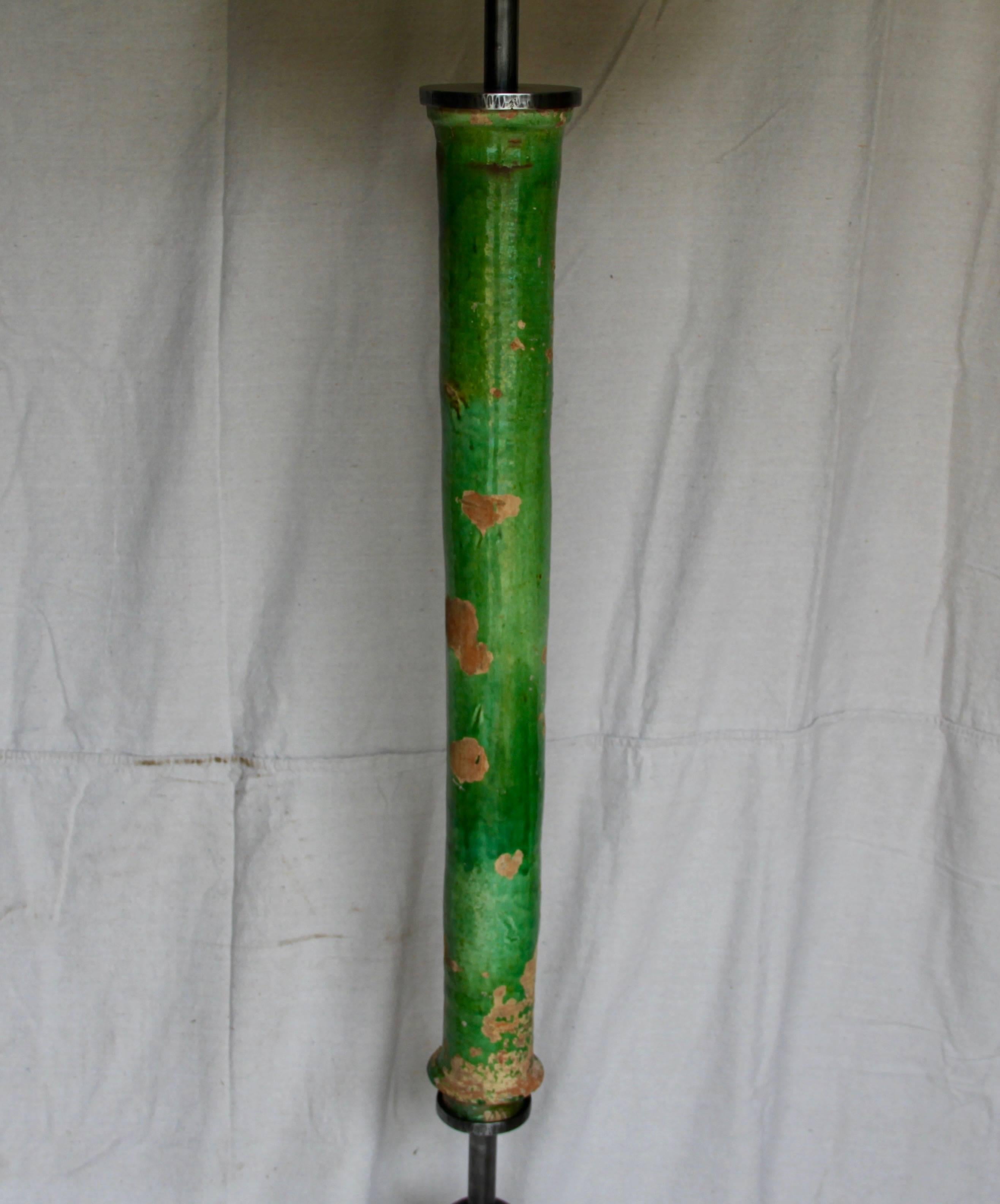 Take a century-old downspout from France, put it on a modern metal base, top it with a shade, and Voila! - You’ve got a one-of-a-kind floor lamp! The terracotta downspout has a thick, worn green glaze and the custom metal base still bears the marks