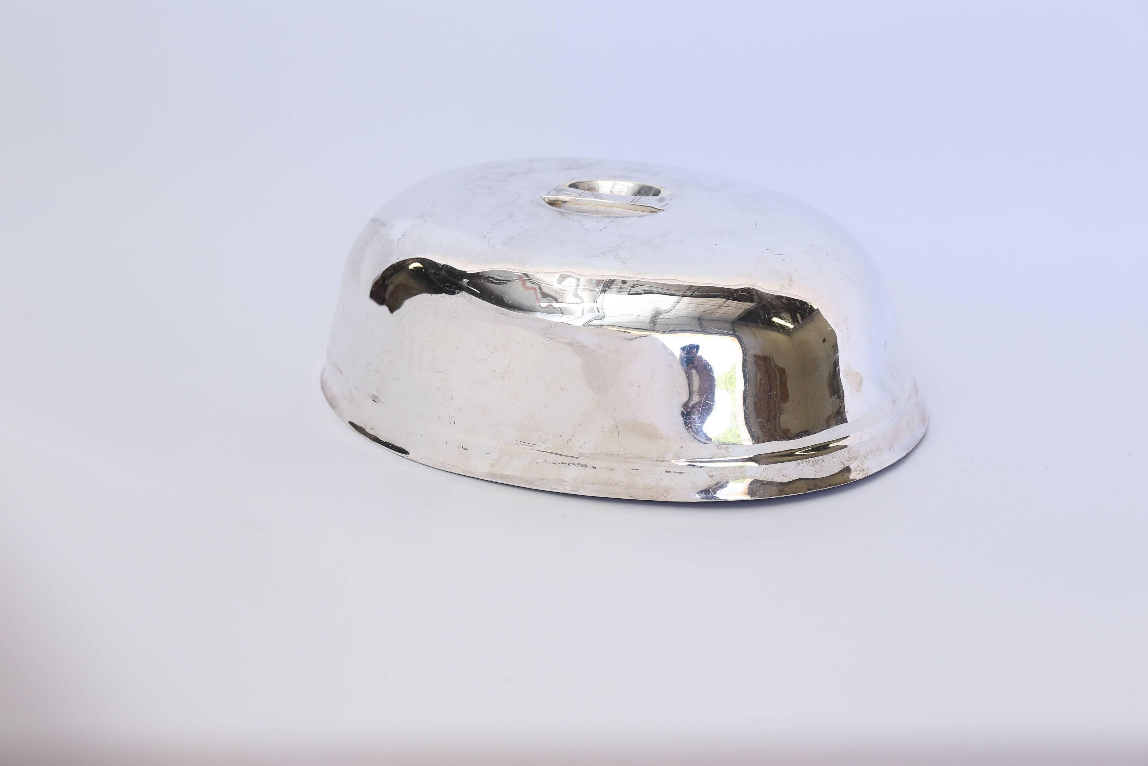 From the legendary Beverly Hills Hotel and Bungalows, a Reed and Barton room service dome of hotel silver circa 1949 per the Reed and Barton hallmark. With a mirror finish and a deco style handle, the marks read: Reed and Barton, Silver Soldered