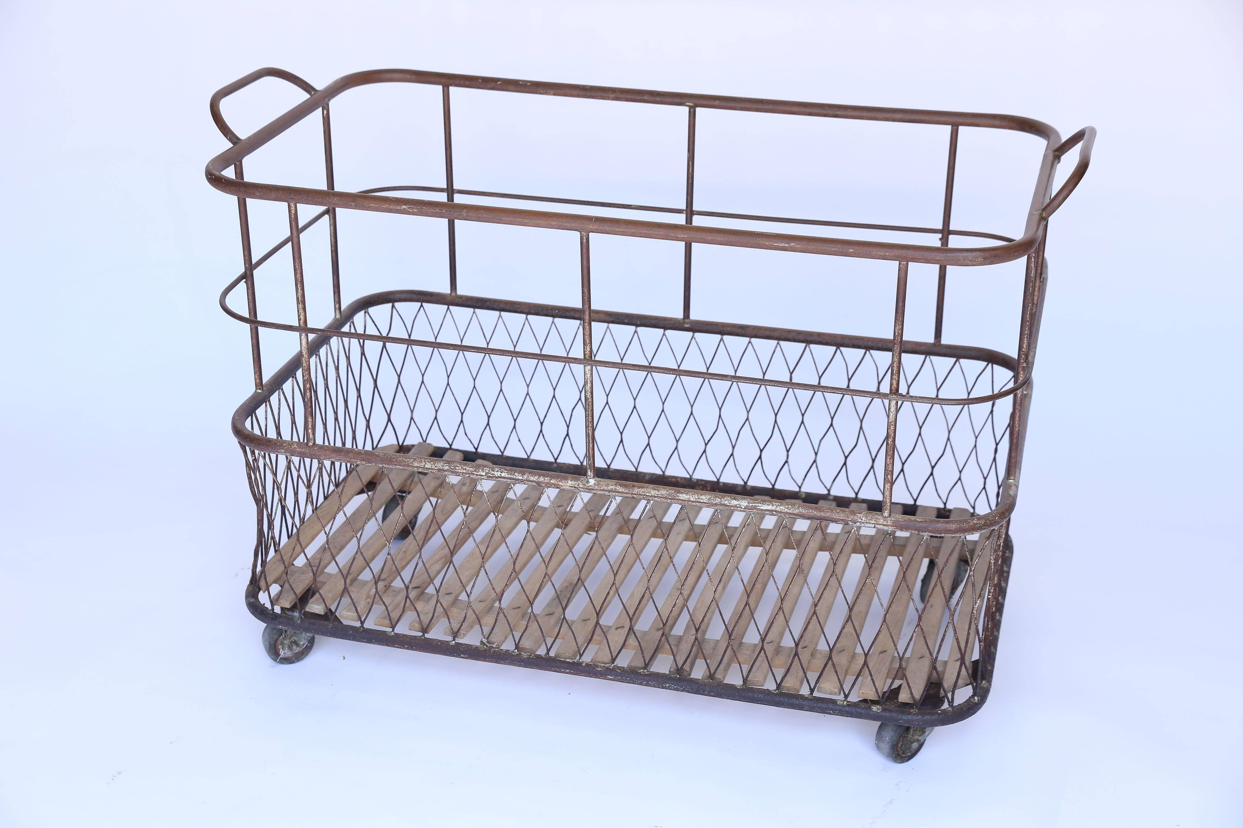 Used for storing and transporting textiles in the mills of France, a metal, wood, and wire linen cart on wheels. Great for storage.